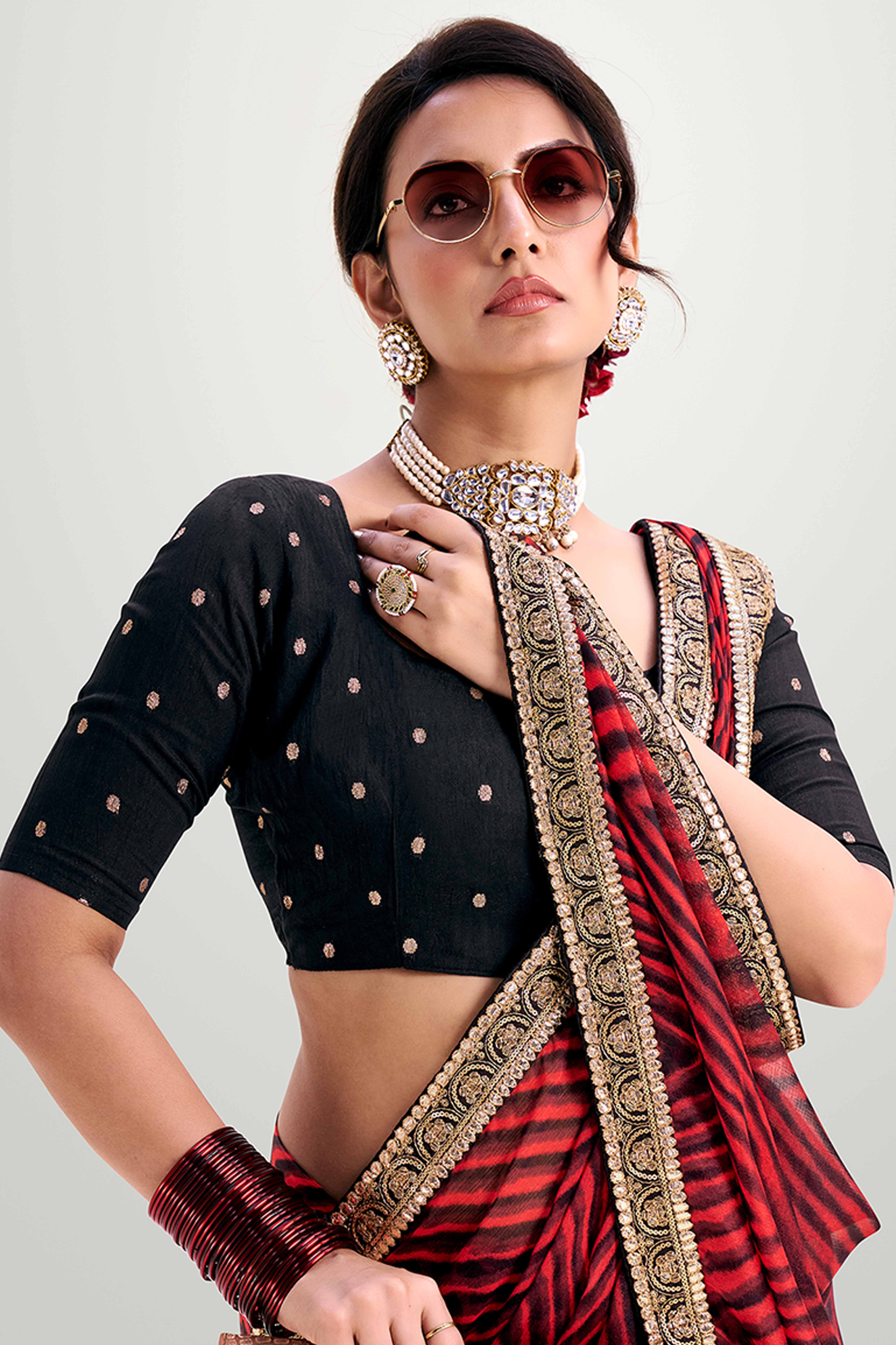 Red Striped Printed Chiffon Saree Enhanced With Sparkling Sequins Embroidered Border Work