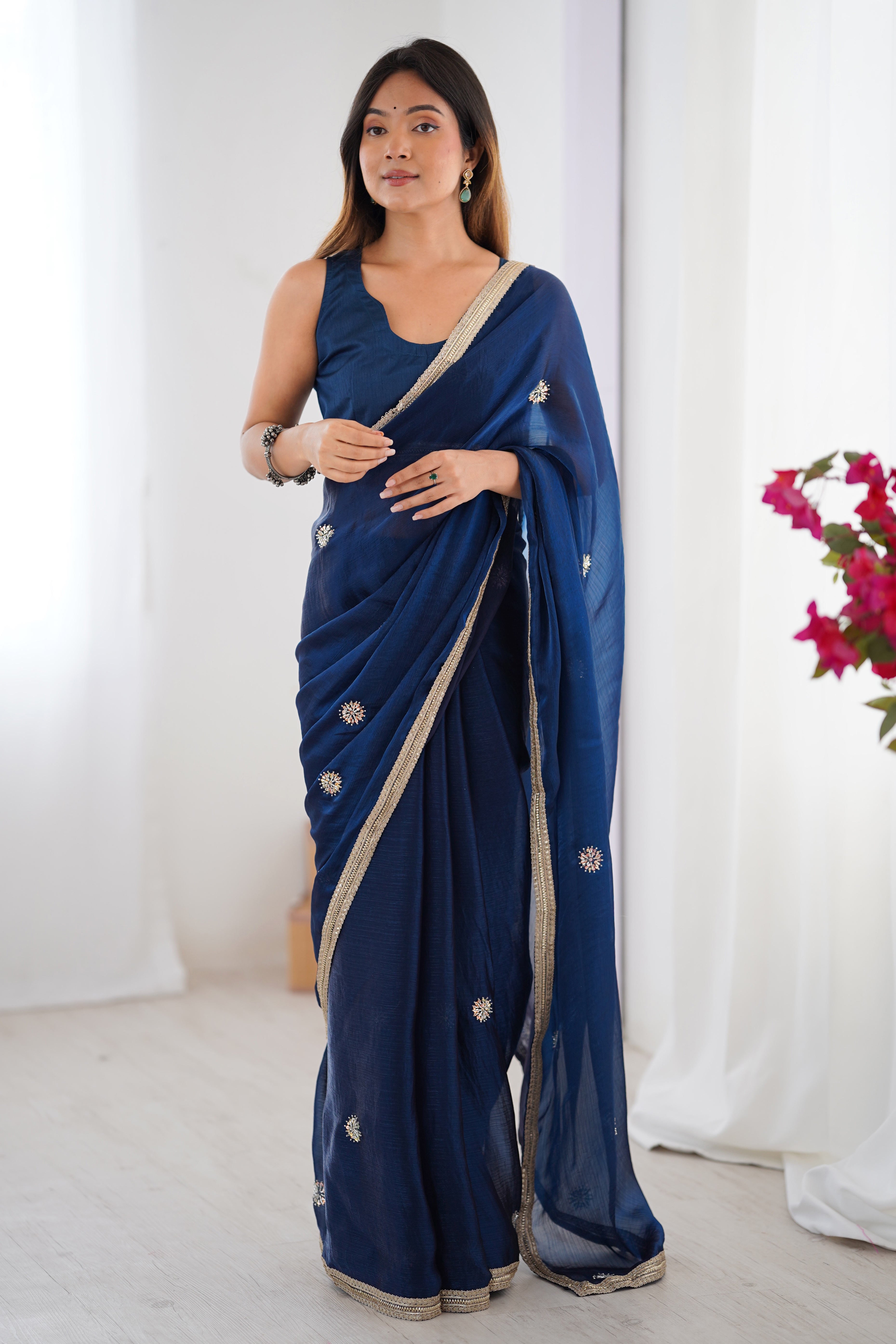 Elegant Blue Organza Saree with Delicate Floral Embellishments and Lace Border