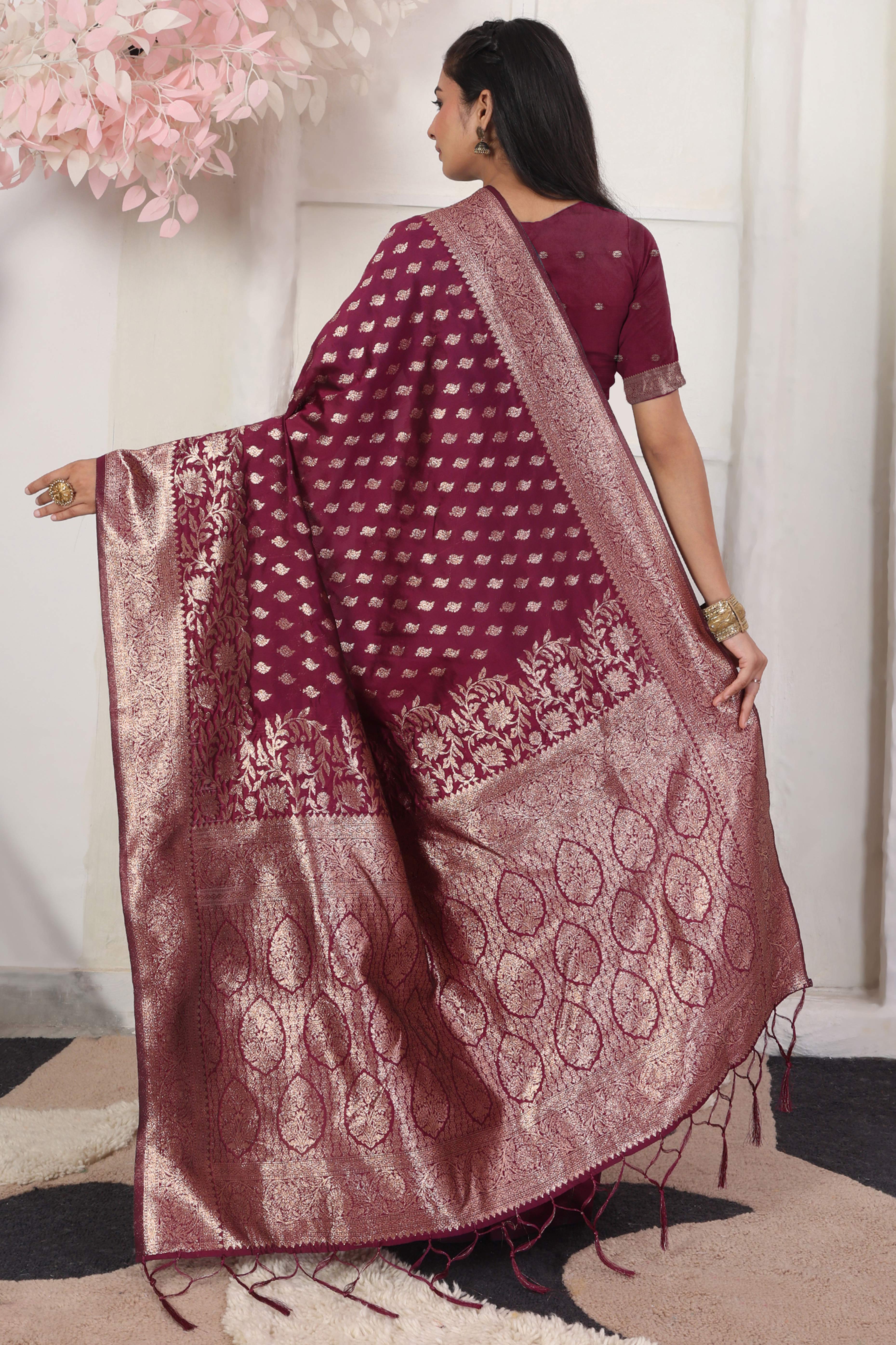 Wine Traditional Lichi Silk Blend Saree Enhanced With Floral Zari Weaving & Tassel Pallu