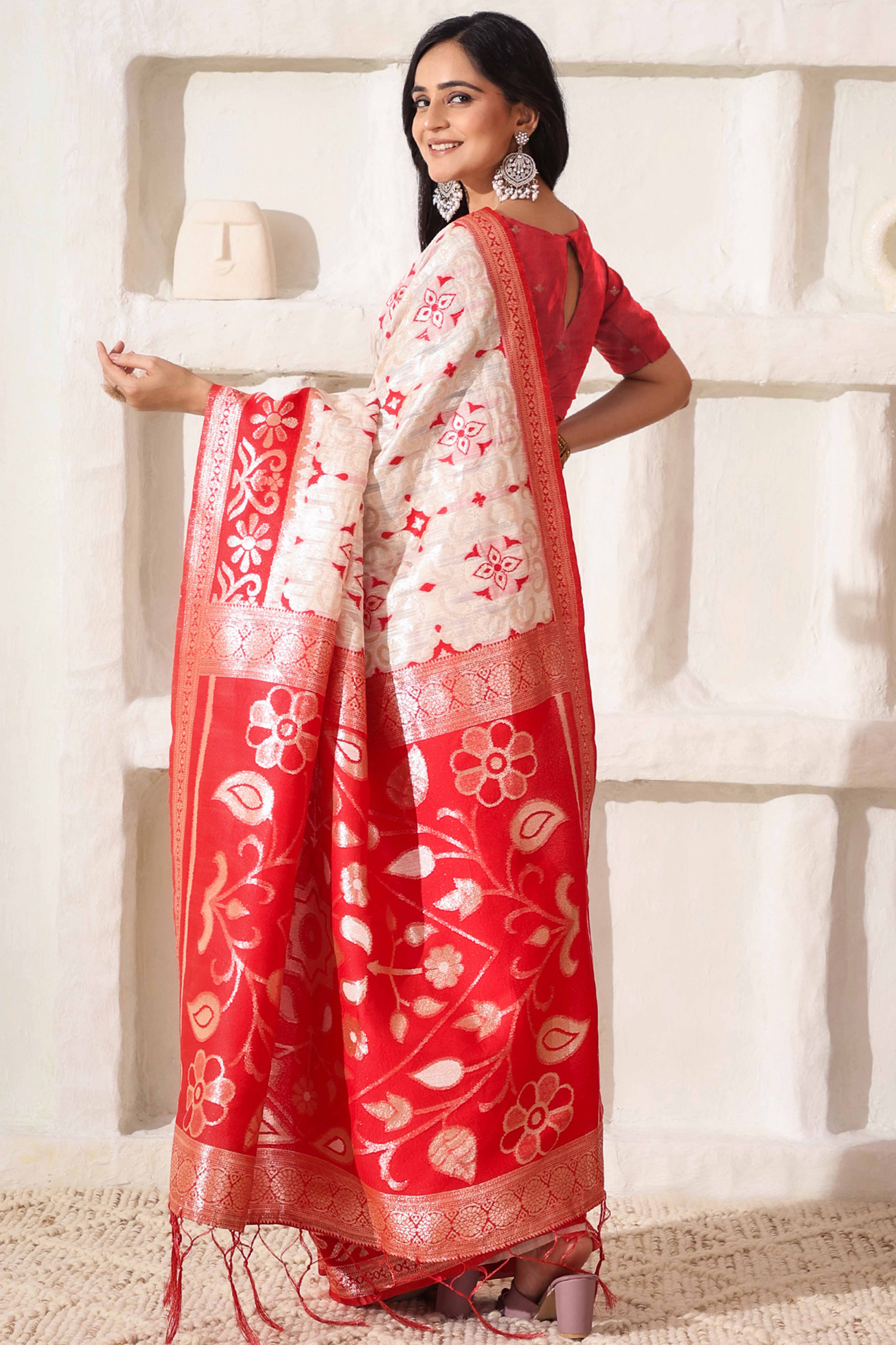 White & Red Linen Cotton Saree Adorned With Intricate Zari Weaving And Tassel Pallu