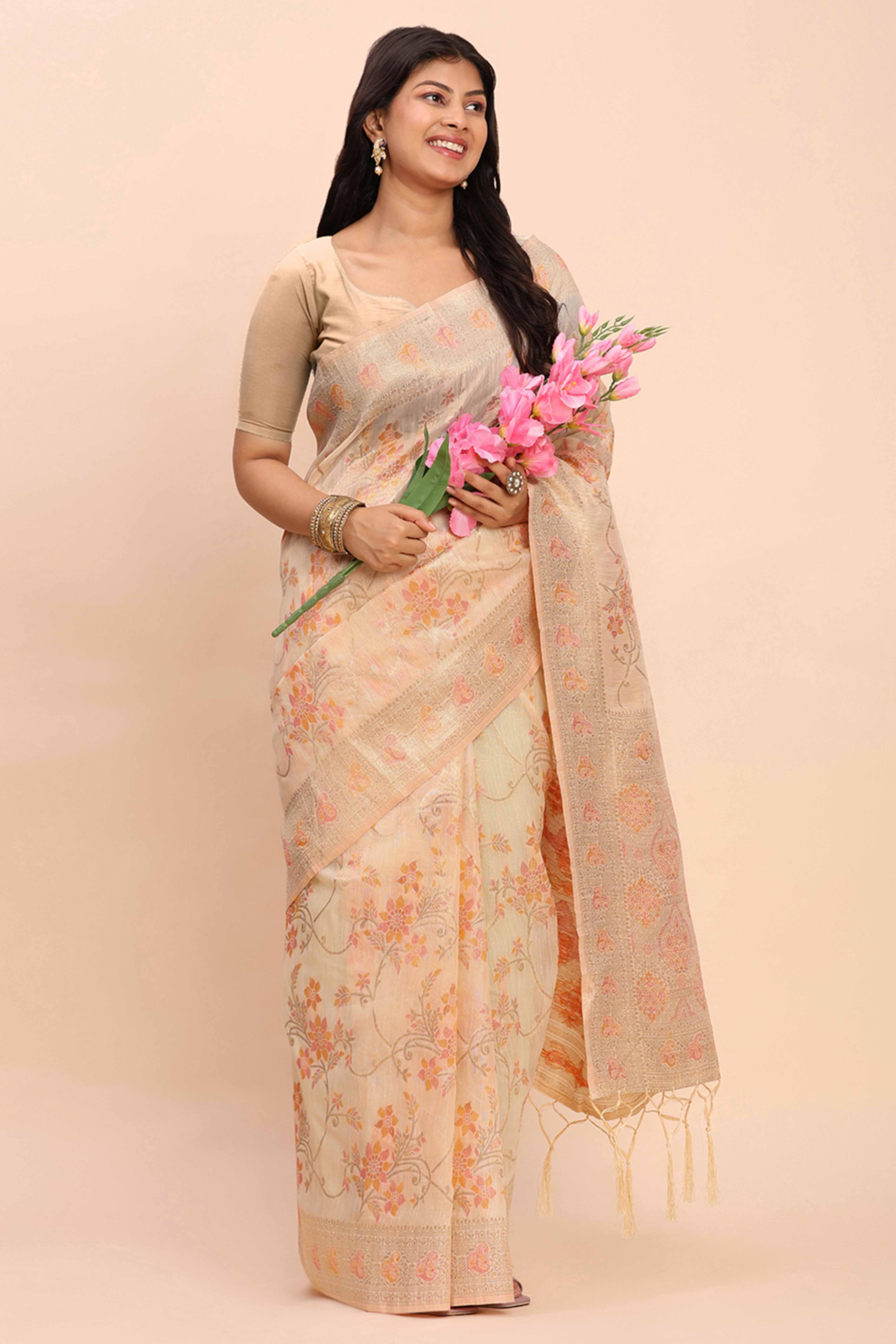 Cream Linen Cotton Saree Showcasing Floral Zari Weaves & A Tasselled Finish Pallu