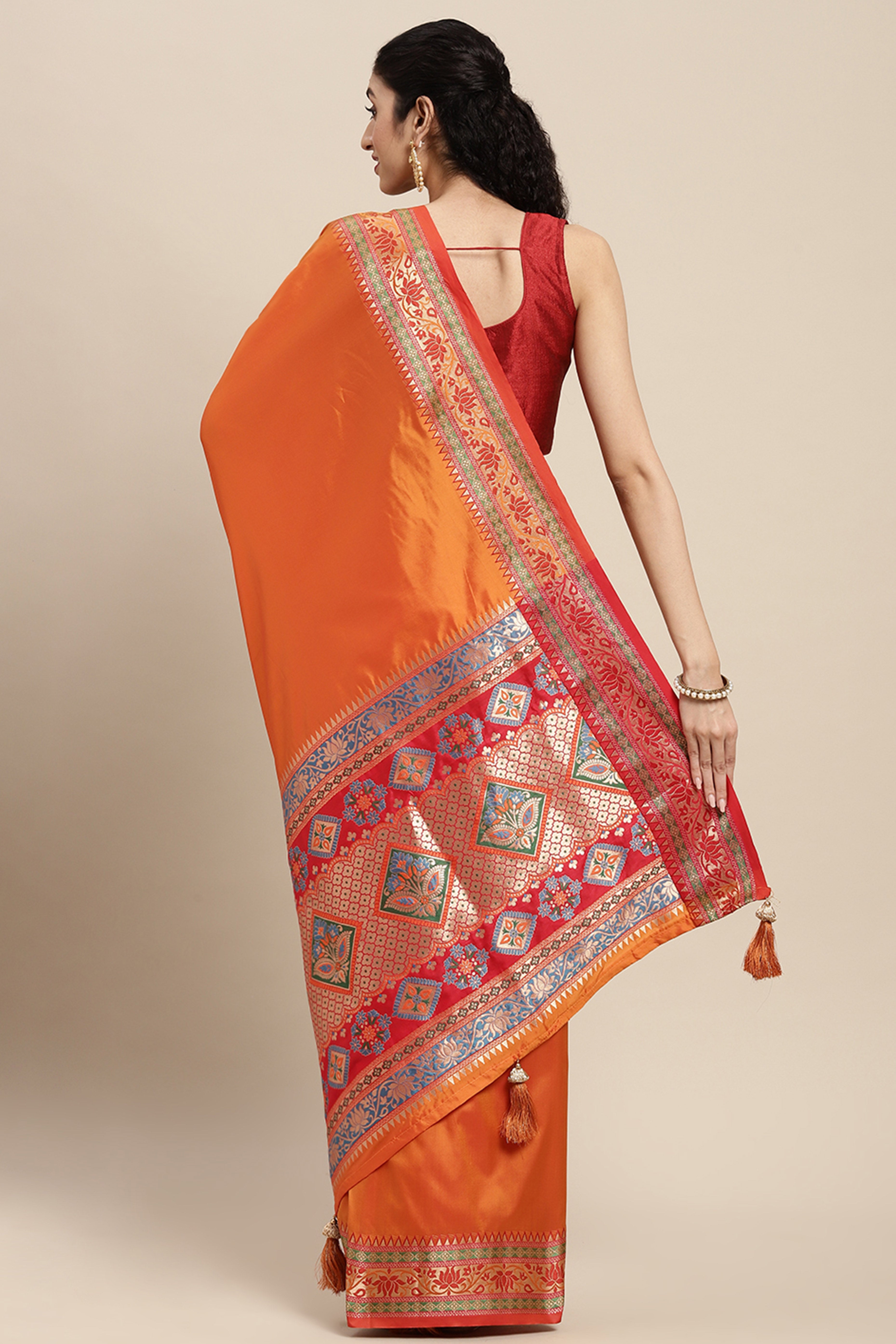 Graceful Orange Solid Saree Highlighted With Floral Zari Weaving On Silk Blend & Tassel Pallu