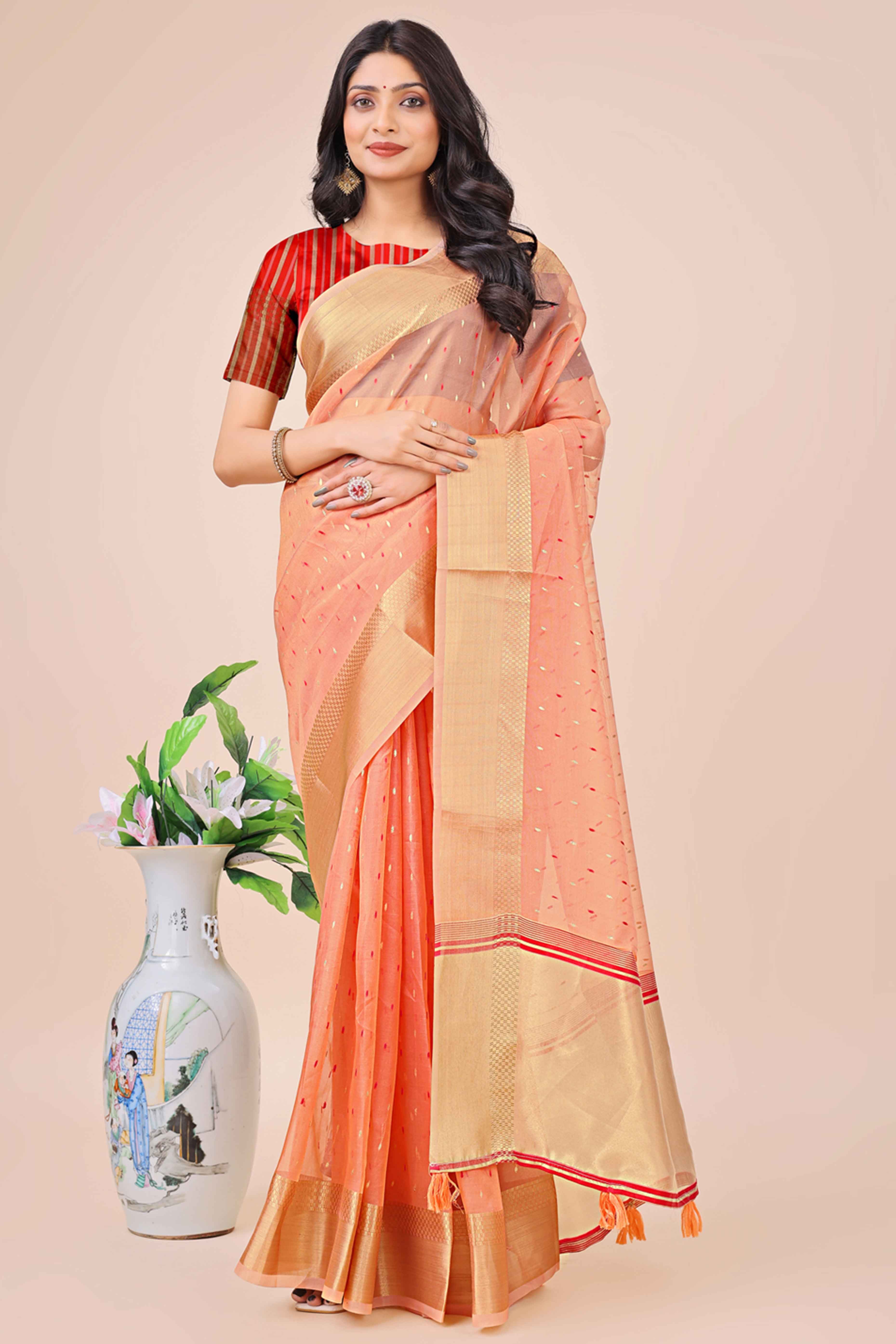 Peach Organza Saree Adorned With Fine Zari Weaving & Stylish Tassel Edging