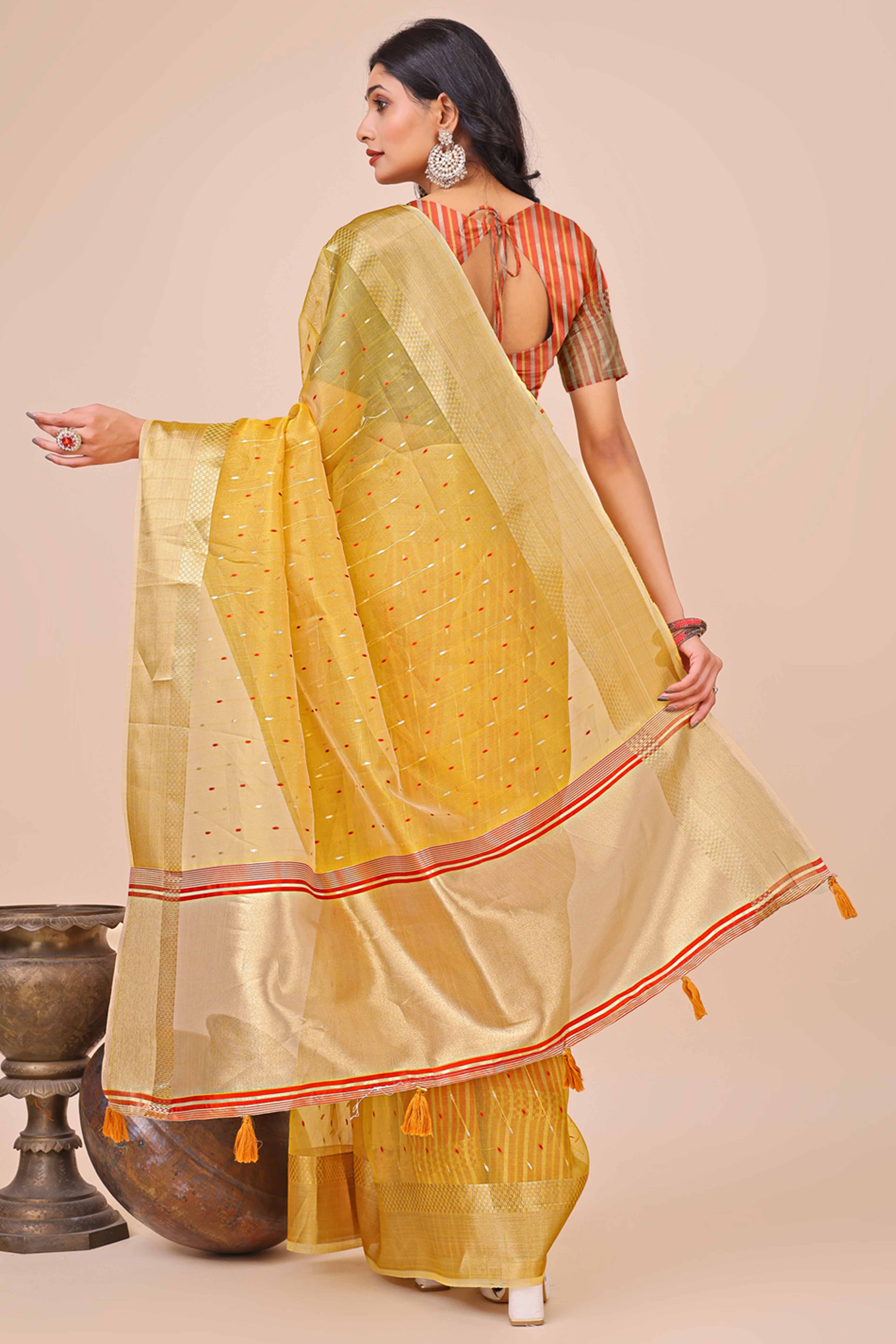 Yellow Organza Saree Adorned With Fine Zari Weaving & Stylish Tassel Edging