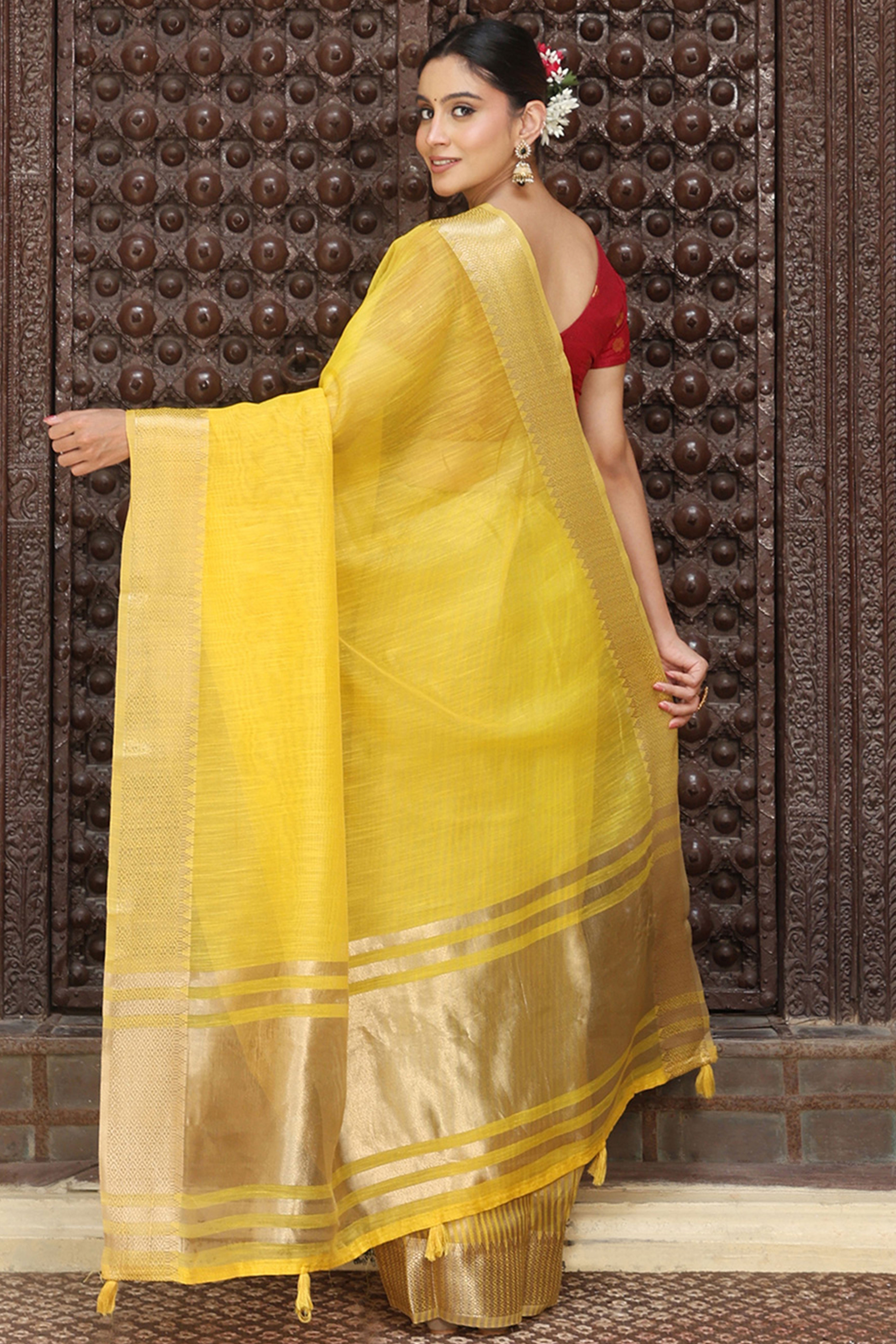 Trendy Yellow Cotton Blend Saree Showcasing Elegant Zari Weaving & Tassel Border Pallu