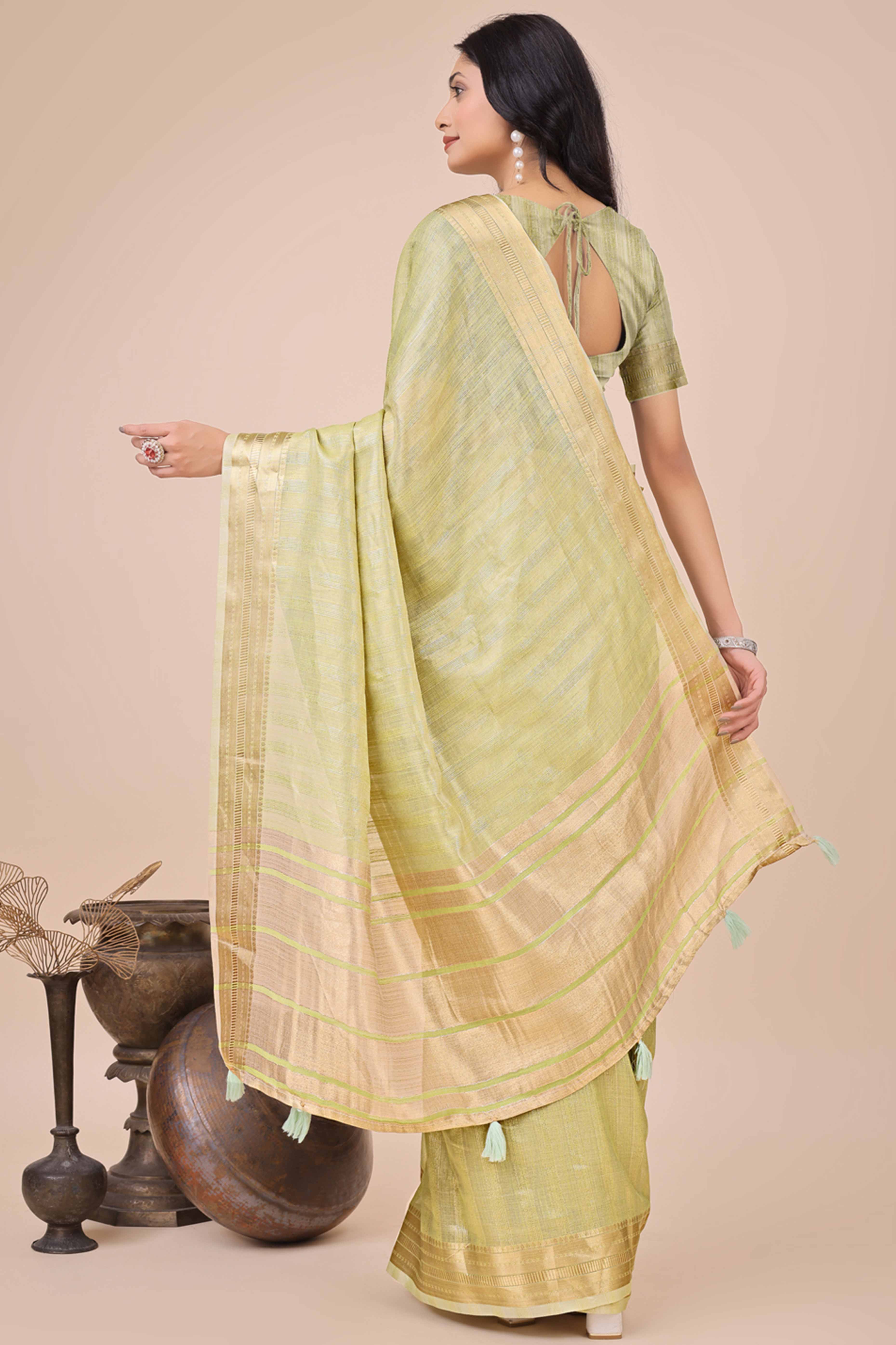 Light Green Organza Saree With Intricate Weave & Elegant Tassel Accents
