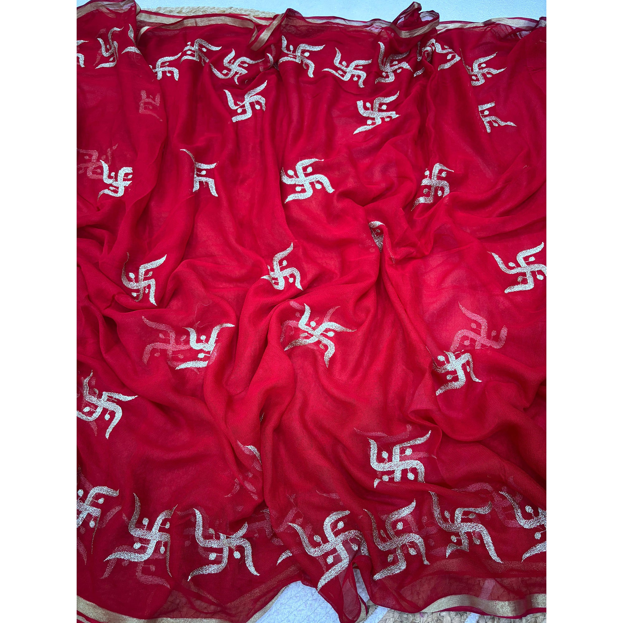 Festive Red Georgette Saree Enhanced with Fine Swastik Embroidered Motifs