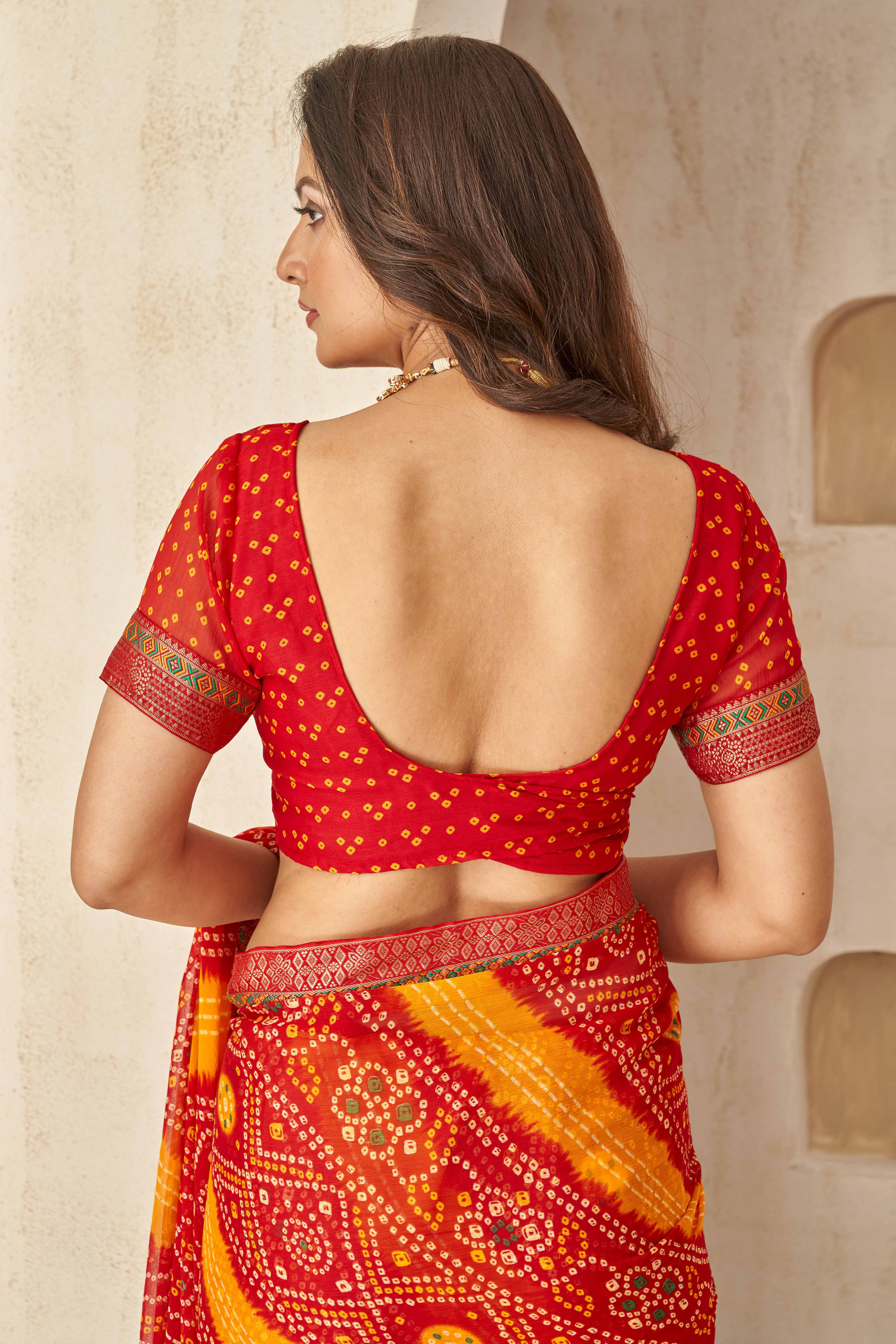 Red & Mustard Bandhani Printed Chiffon Saree Enhanced with Delicate Lace Border Work