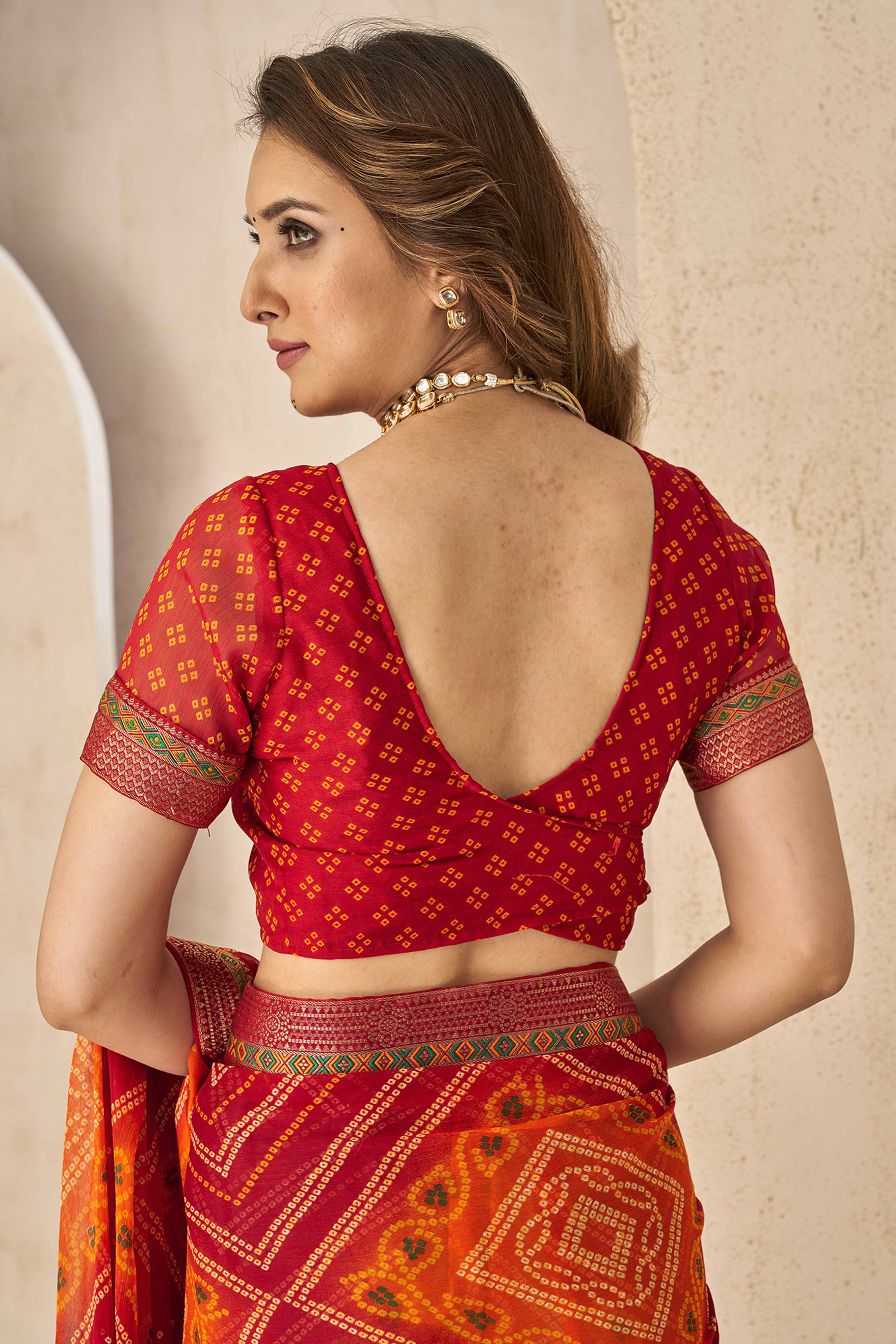Maroon & Orange Bandhani Printed Chiffon Saree Enhanced with Delicate Lace Border Work