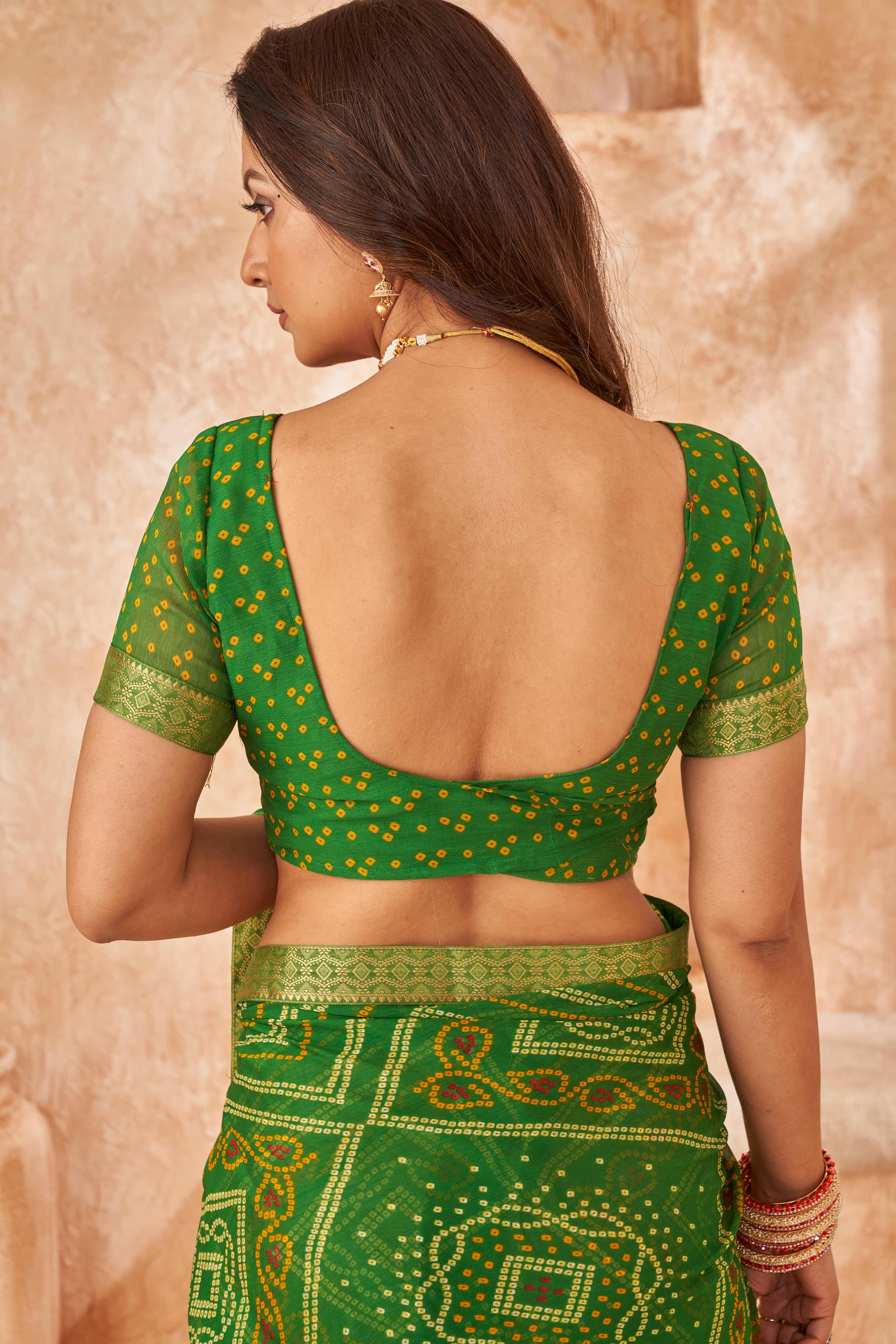 Green Chiffon Saree Featuring Traditional Bandhani Prints & A Graceful Lace Edge