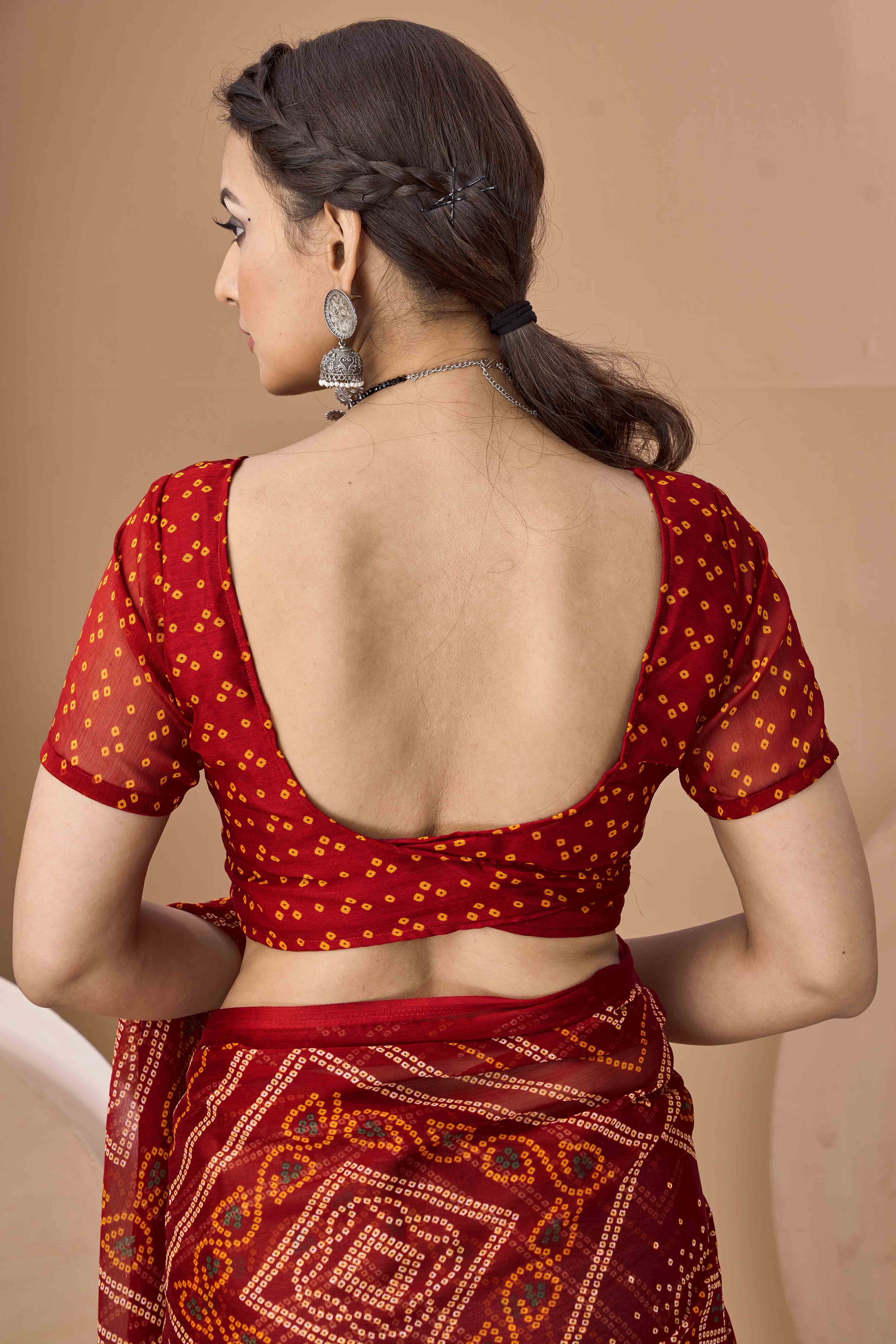 Maroon Bandhani Printed Chiffon Saree Accented With Intricate Lace Border Work