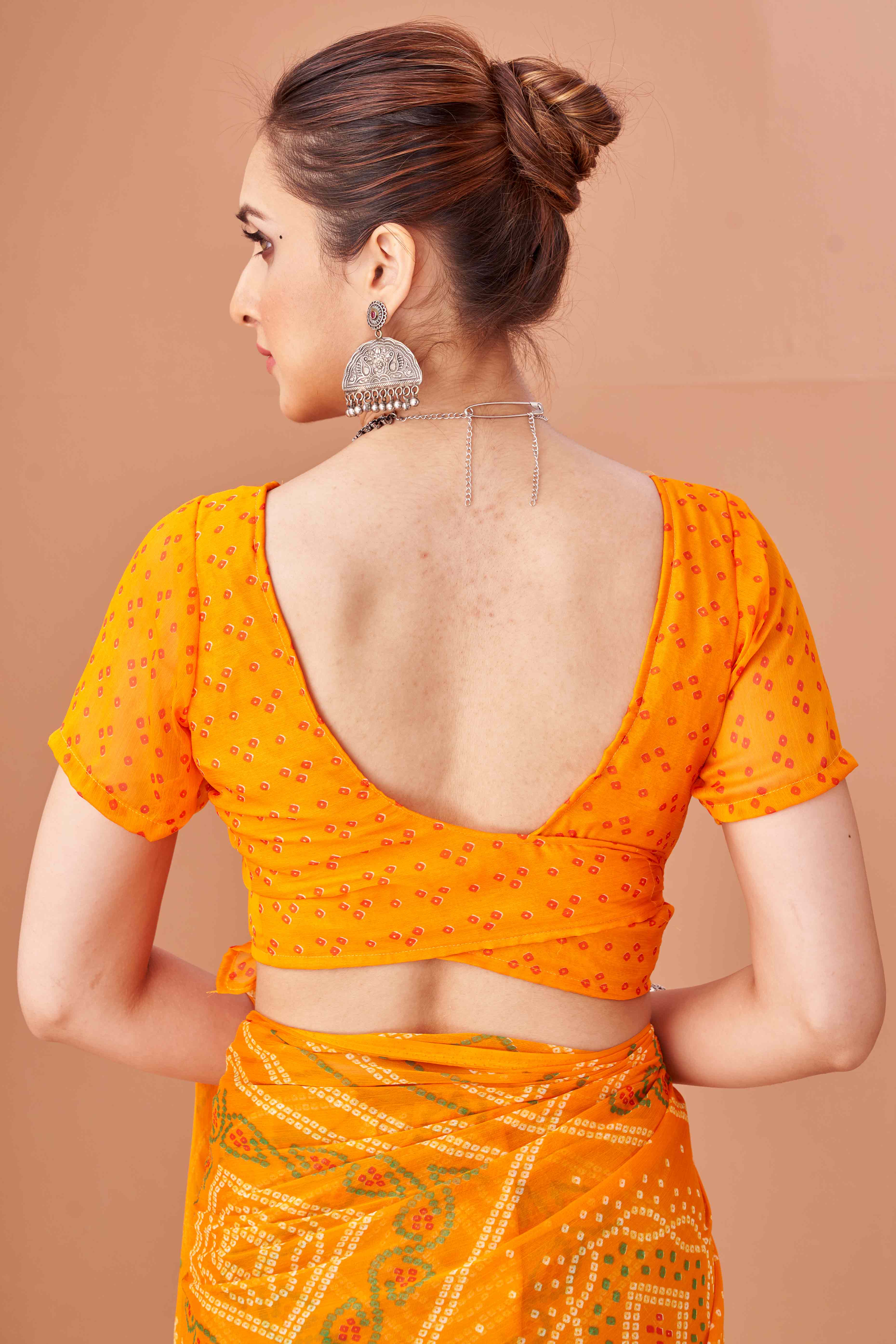 Mustard Bandhani Printed Chiffon Saree Accented With Intricate Lace Border Work