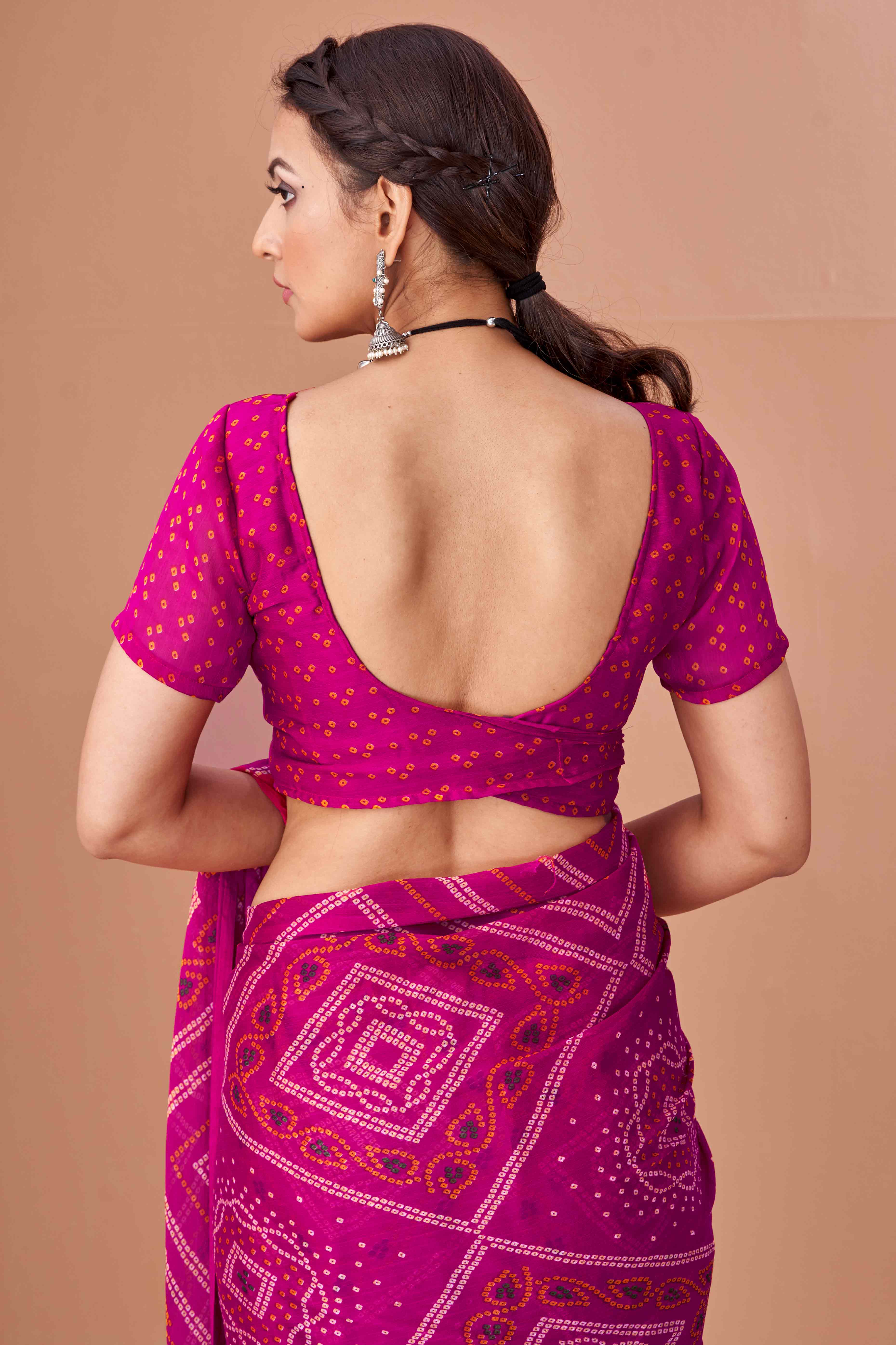 Magenta Bandhani Printed Chiffon Saree Accented With Intricate Lace Border Work