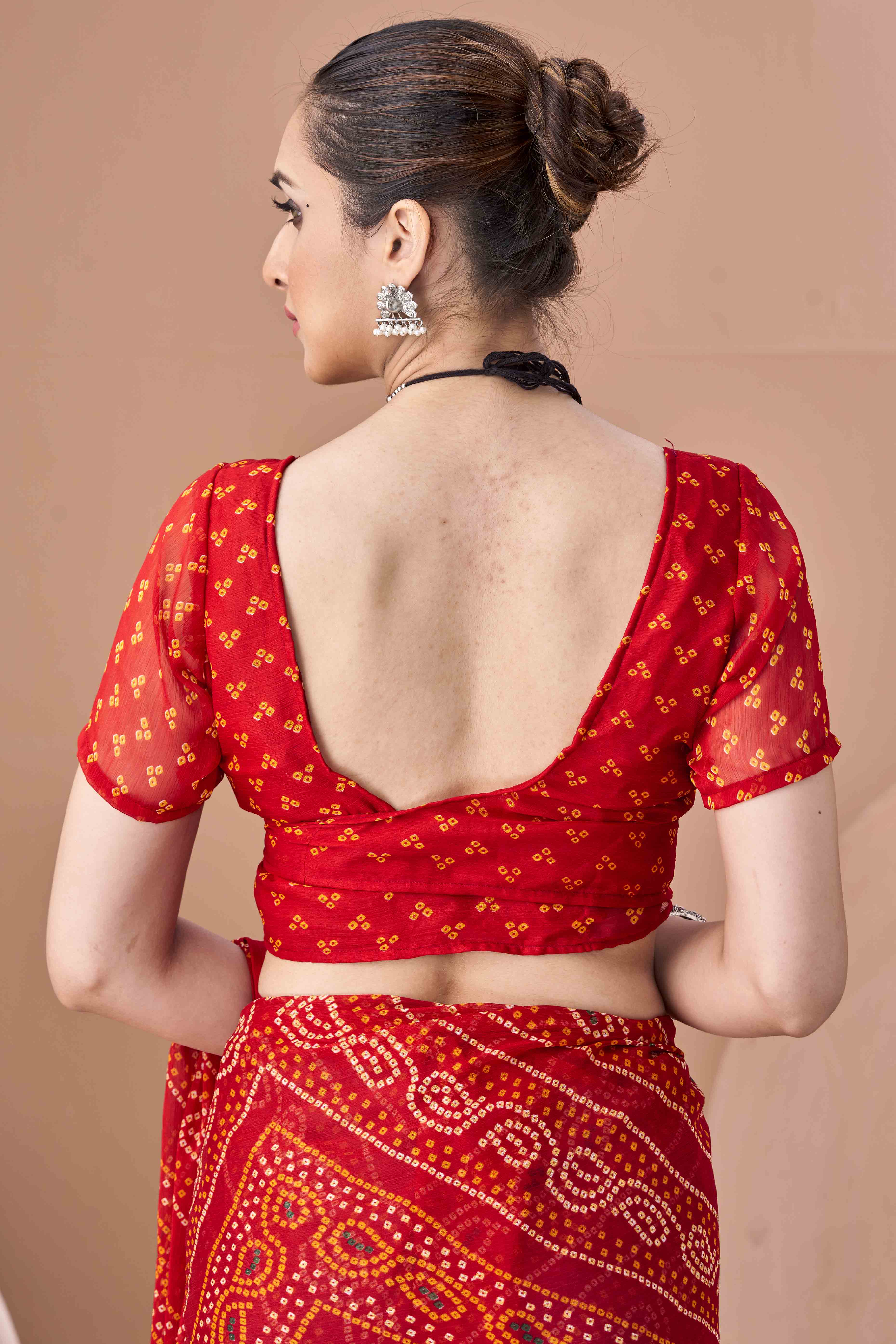 Red Bandhani Printed Chiffon Saree Accented With Intricate Lace Border Work