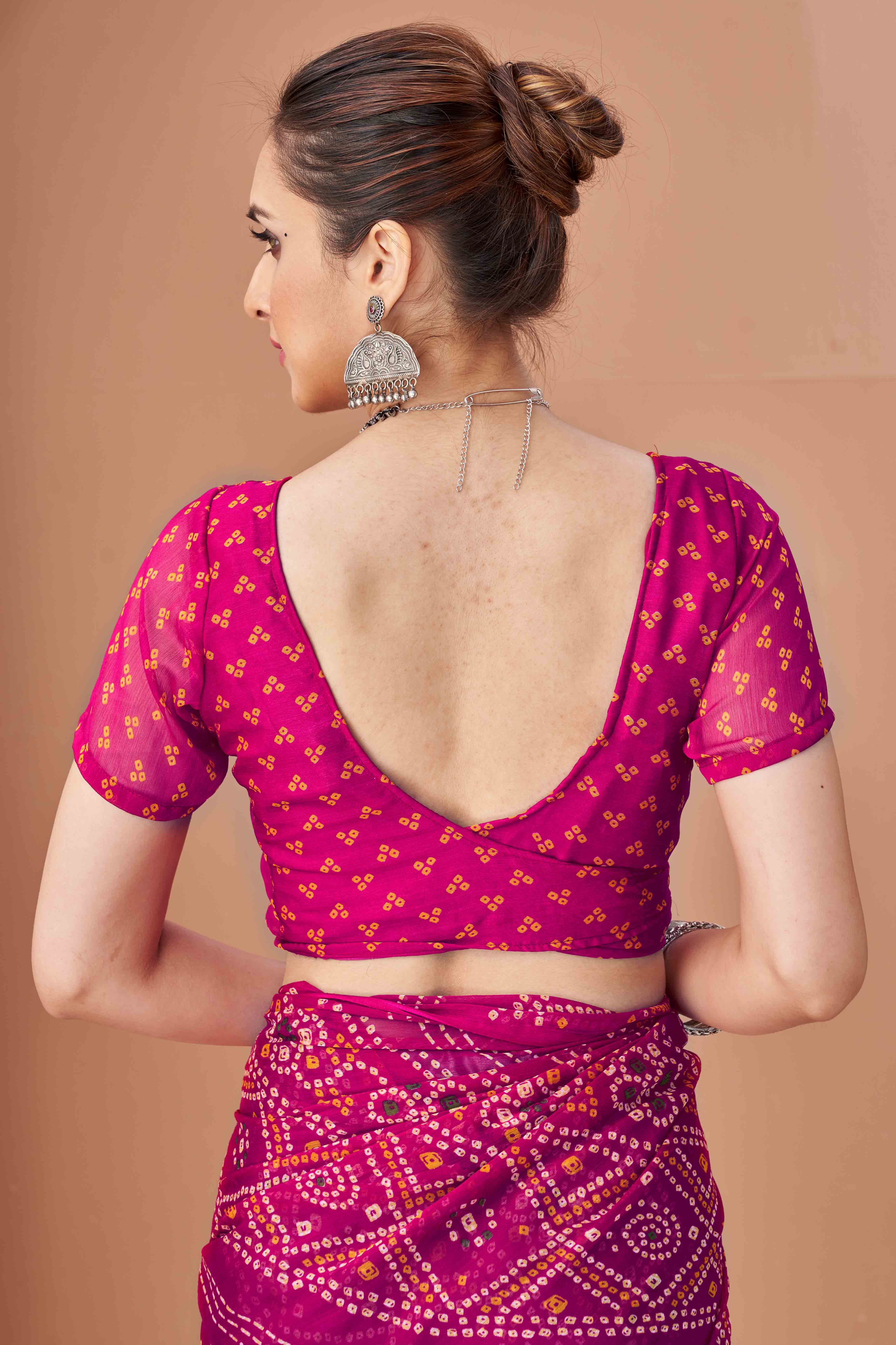 Magenta Bandhani Printed Chiffon Saree Accented With Intricate Lace Border Work