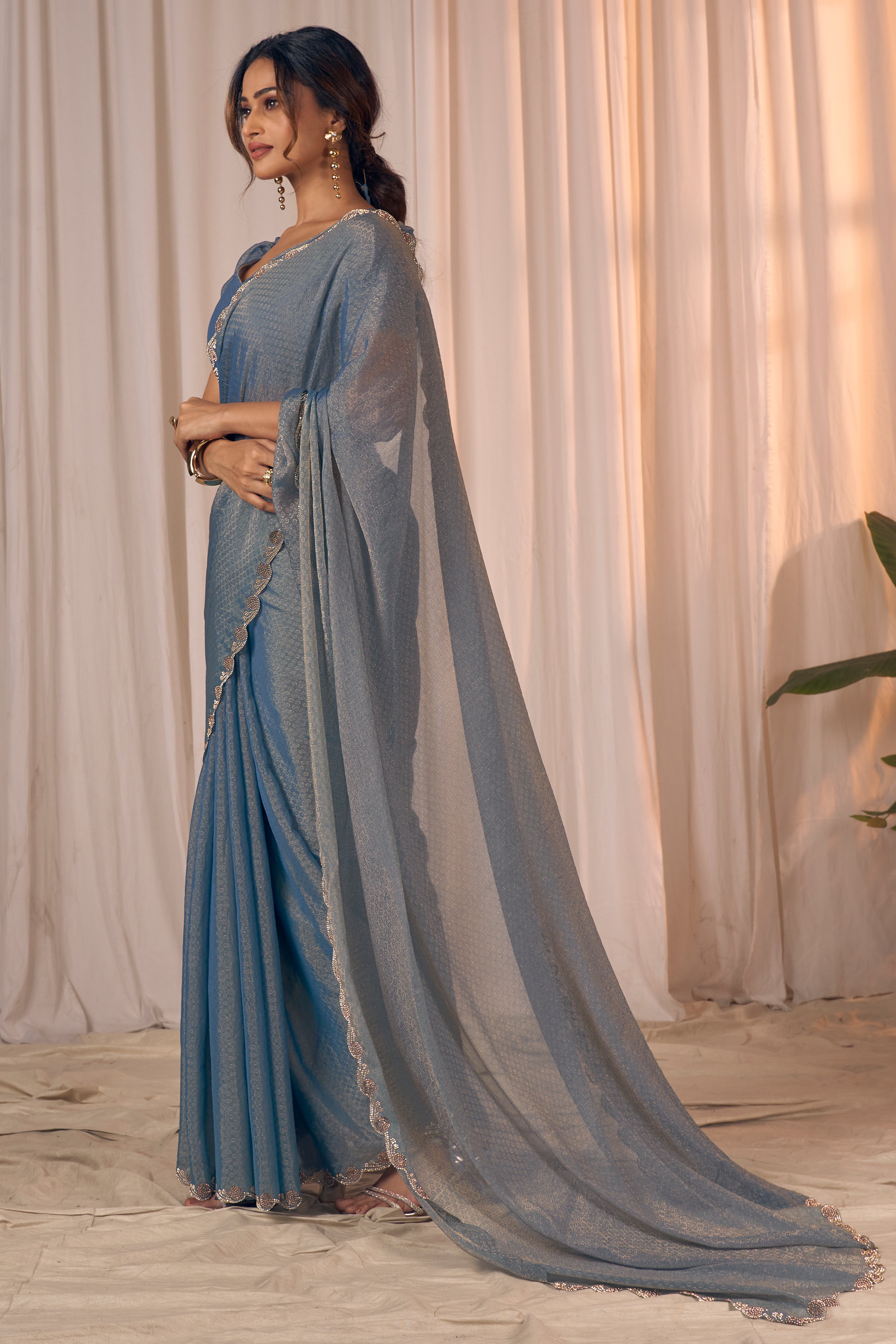 Designer Bluish Grey Georgette Saree Adorned With An Elegant Zarkan Cutwork Border