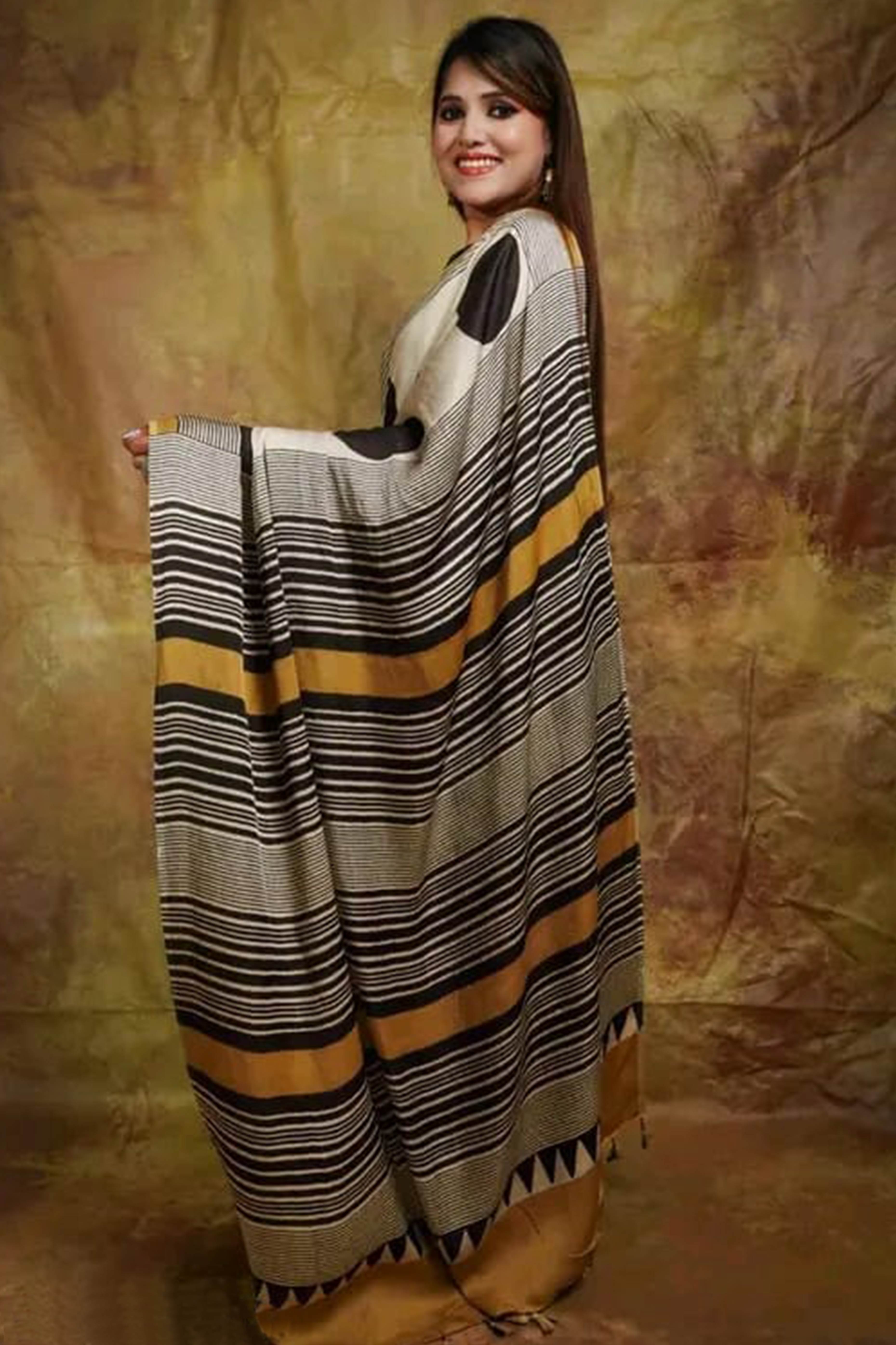 Graceful Offwhite Satin Saree Featuring Geometric & Striped Print With Tassel Pallu