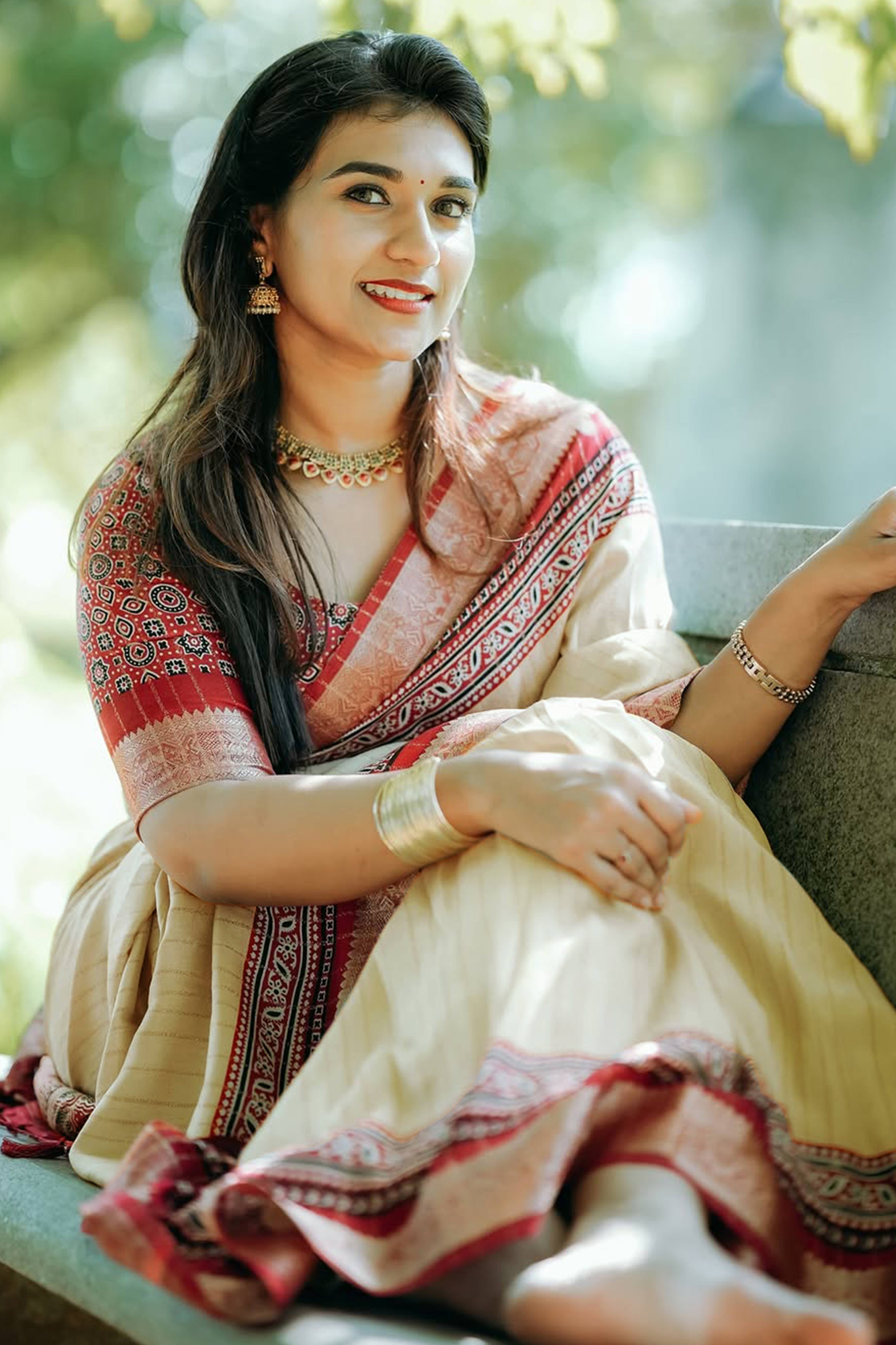 Graceful Light Chikoo Dola Silk Saree Featuring Striped Weave & Floral Border