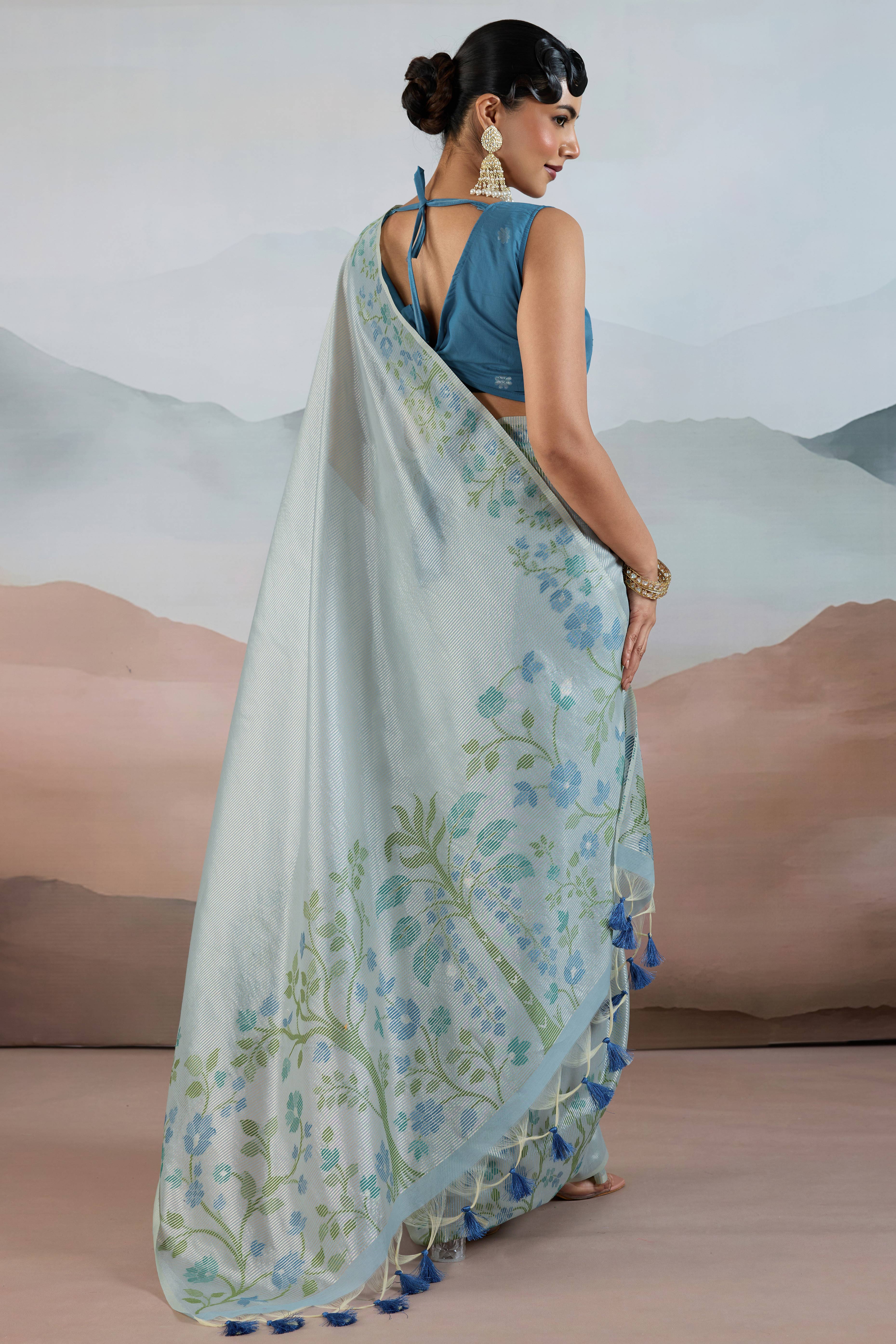 Blue Tissue Silk Saree Showcasing Floral & Striped Weaving With Tassel Adornment