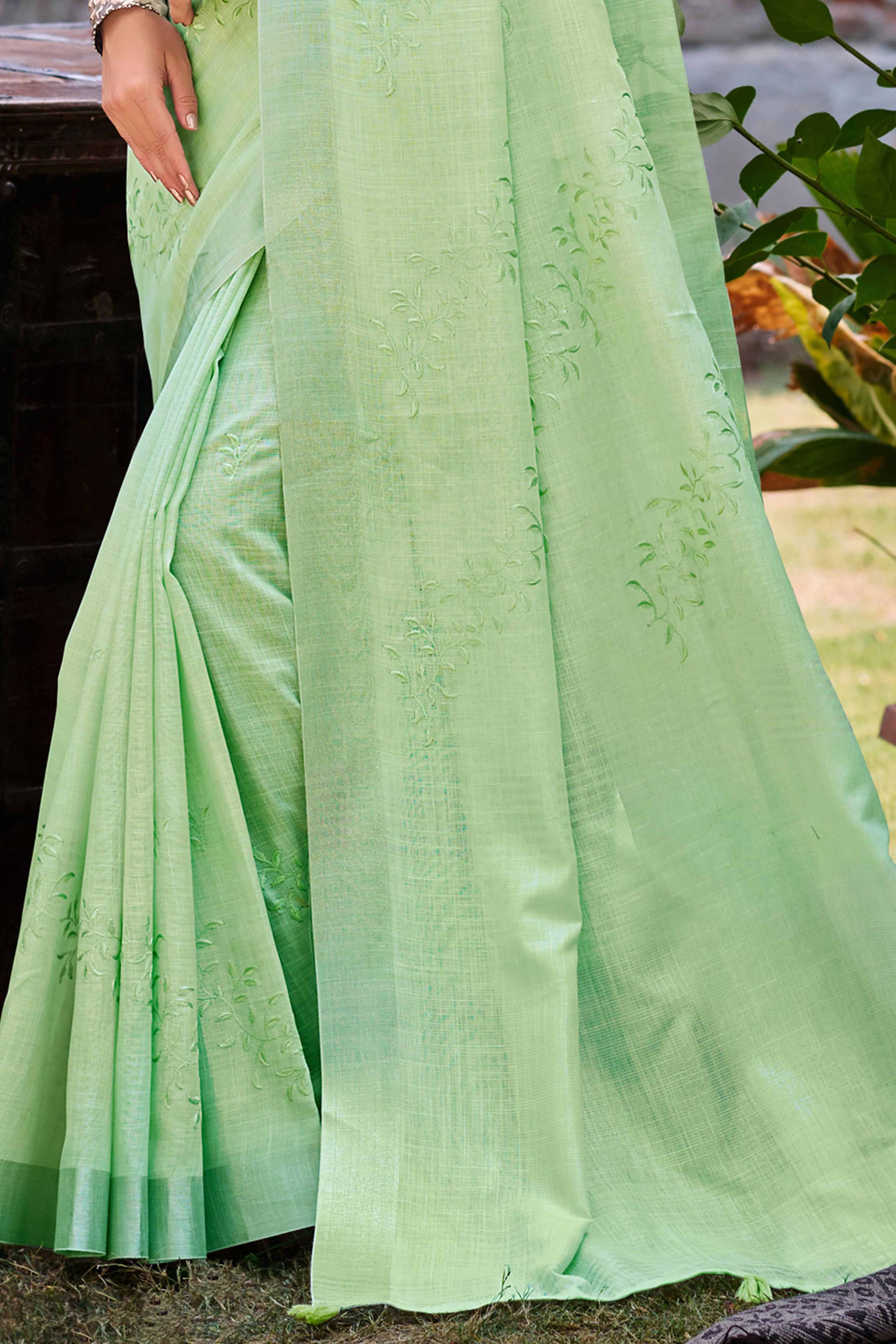 Elegant Green Linen Saree Featuring Intricate Woven & Embroidered Patterns