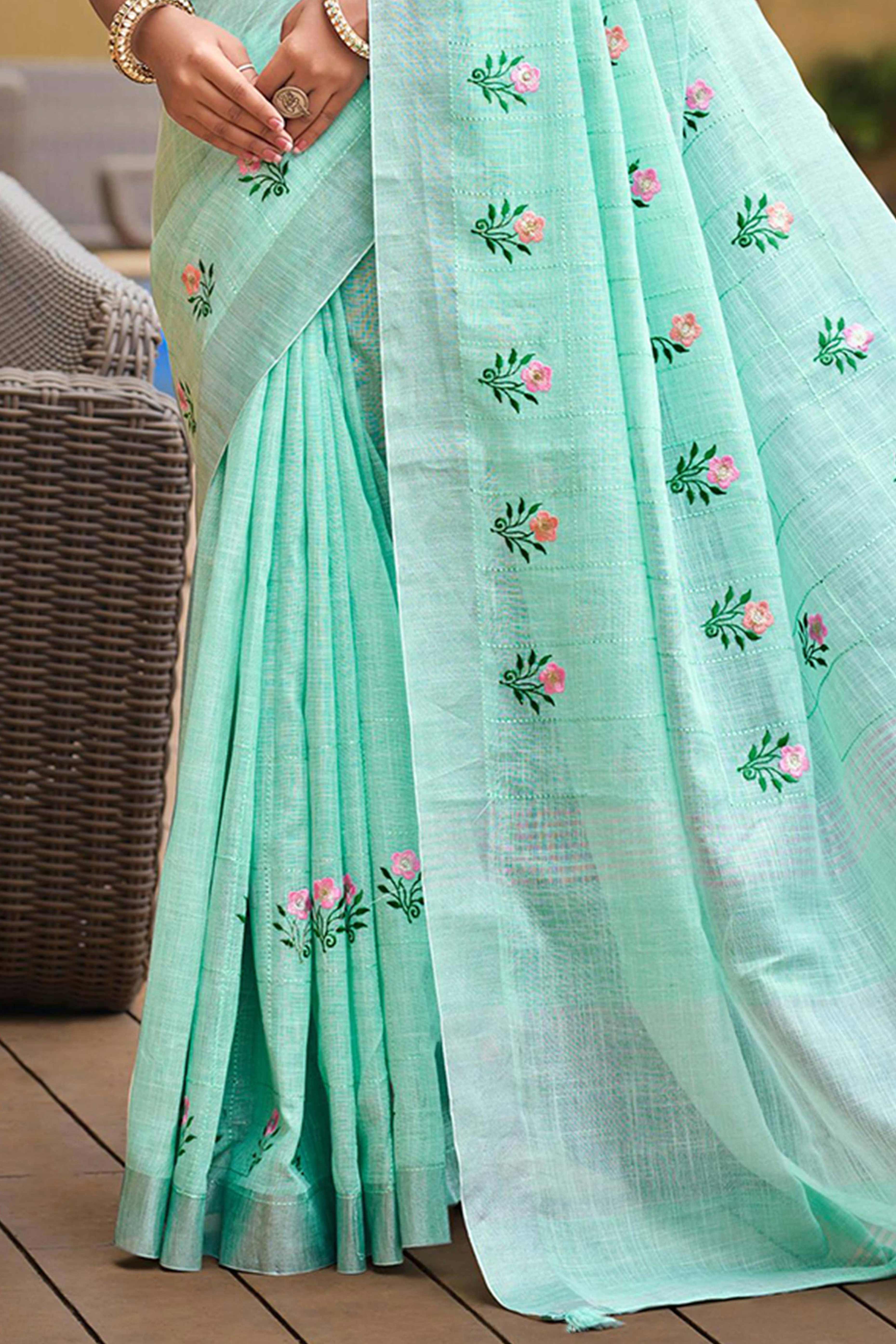 Captivating Turquoise Floral Thread Embroidered Linen Saree With Elegant Weaving Border
