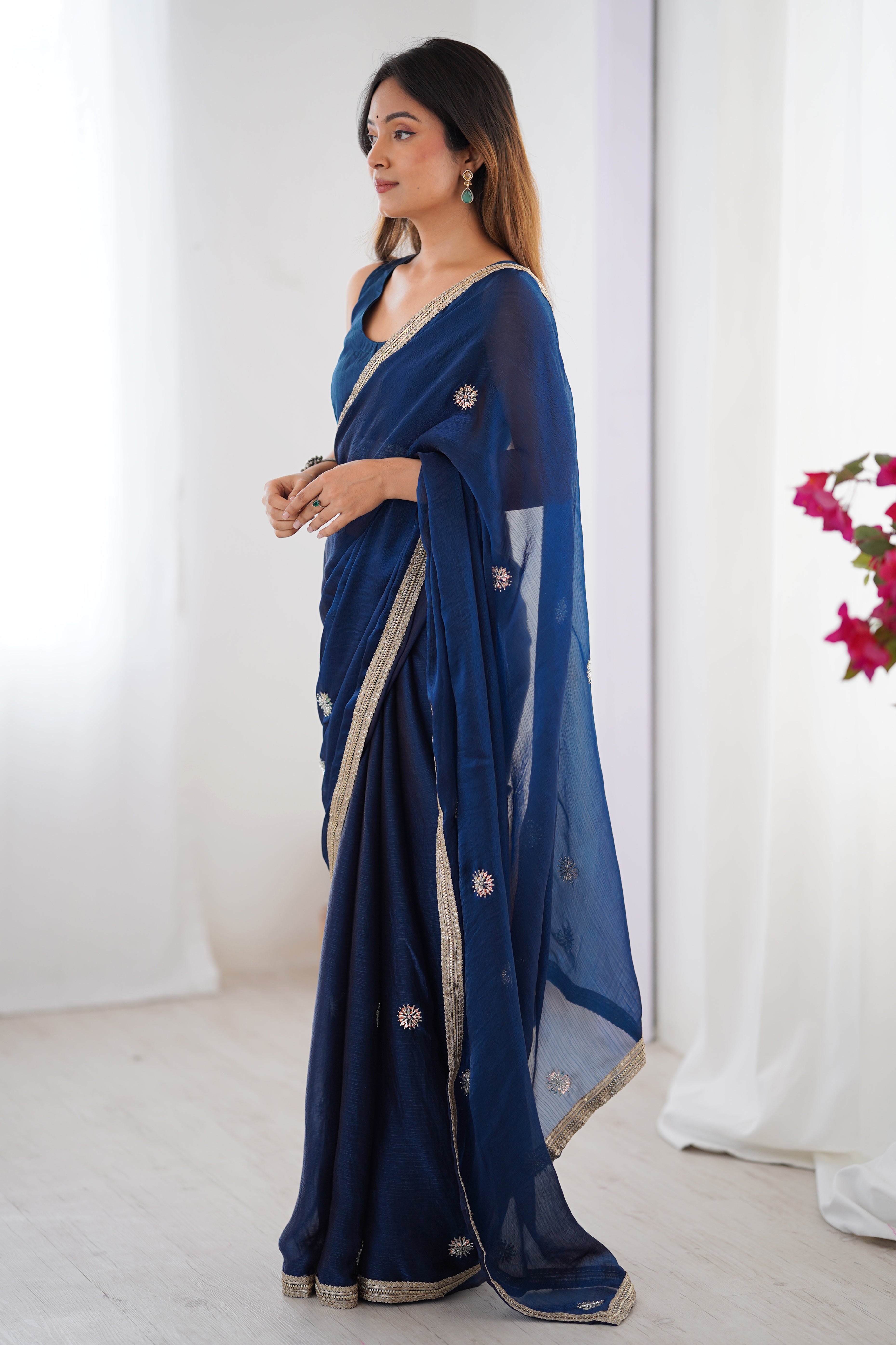 Elegant Blue Organza Saree with Delicate Floral Embellishments and Lace Border