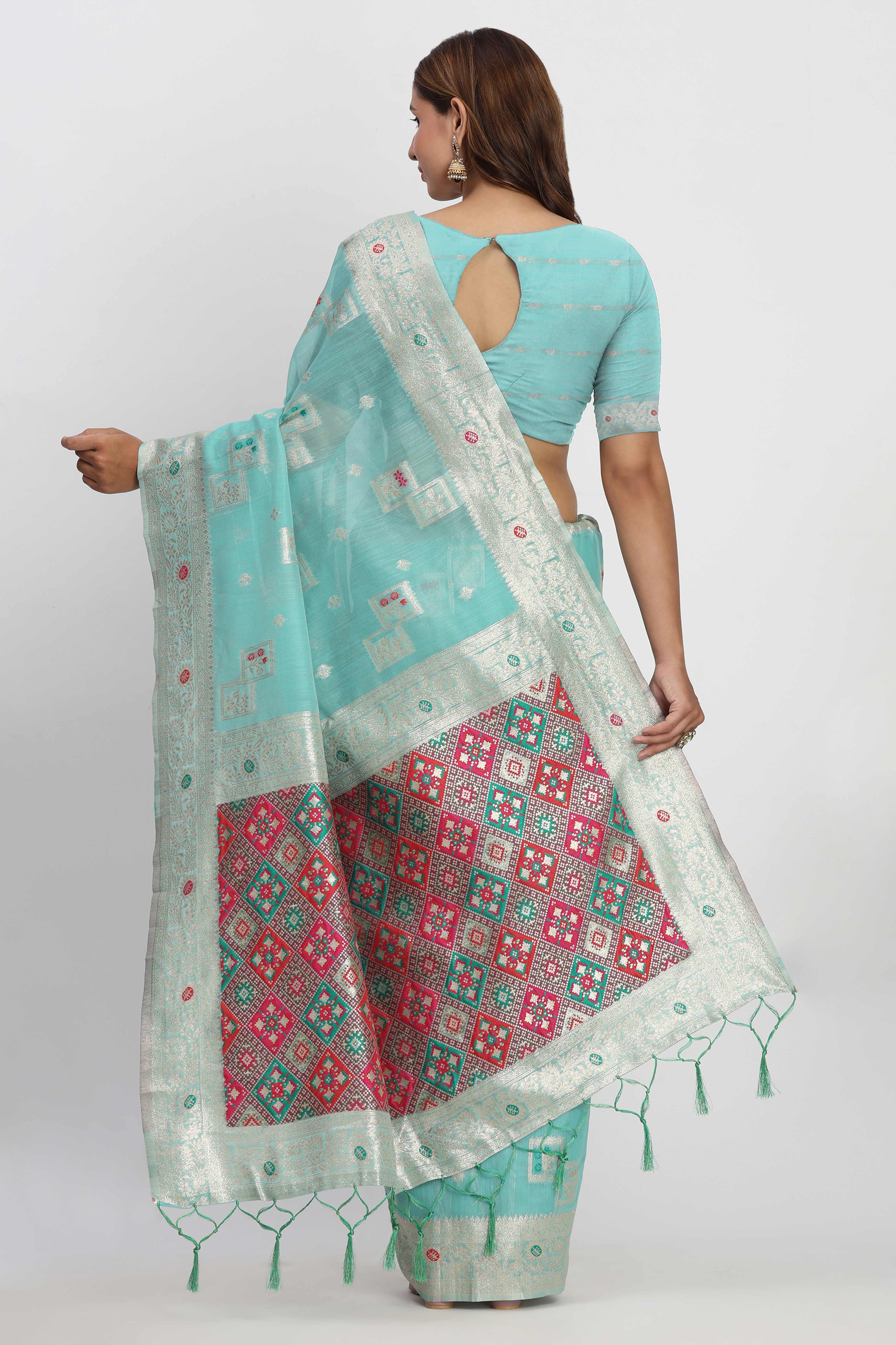 Floral Zari Weaving Brings Regal Beauty To This Turquoise Linen Cotton Saree With Tassel Accents