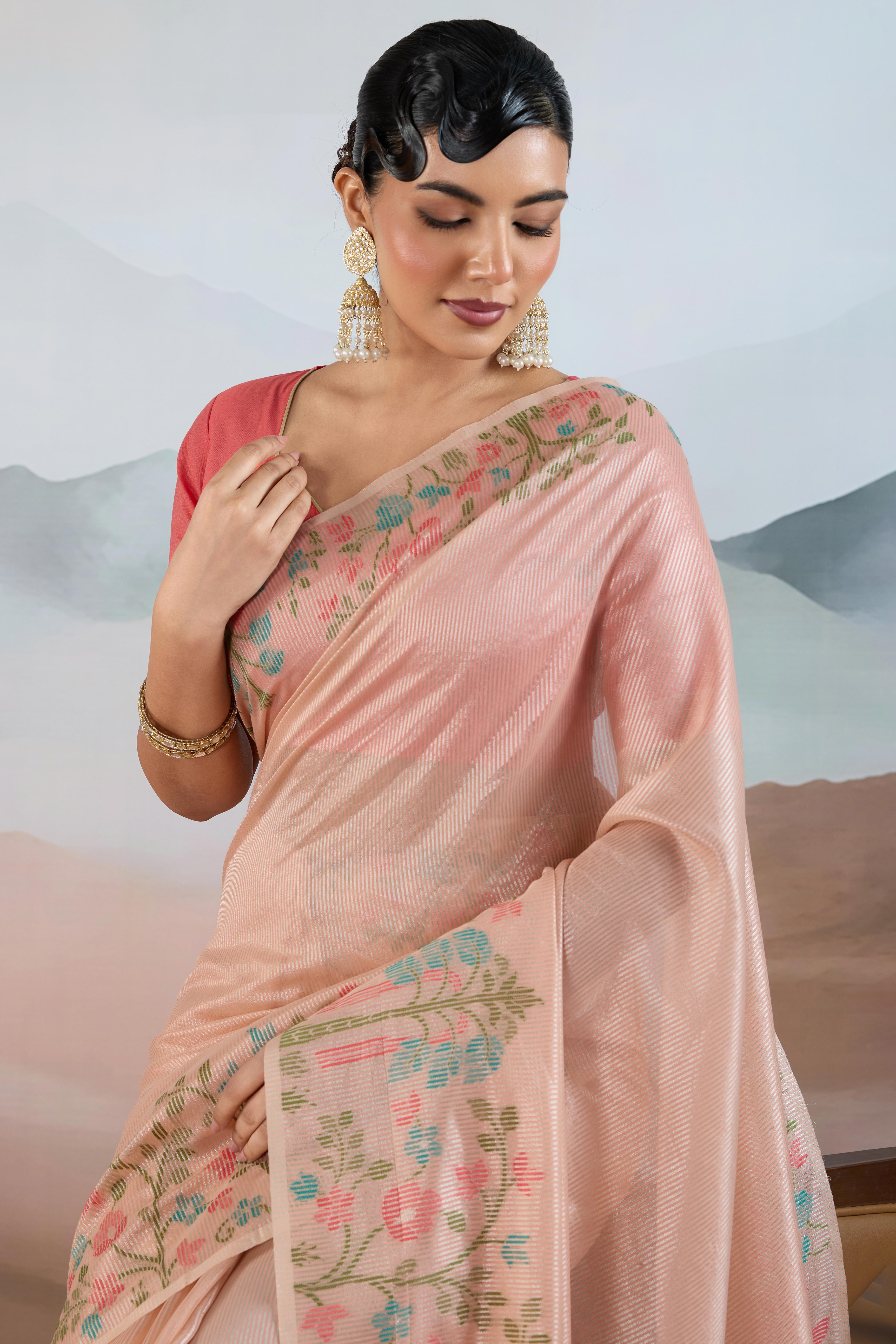 Peach Tissue Silk Saree Showcasing Floral & Striped Weaving With Tassel Adornment