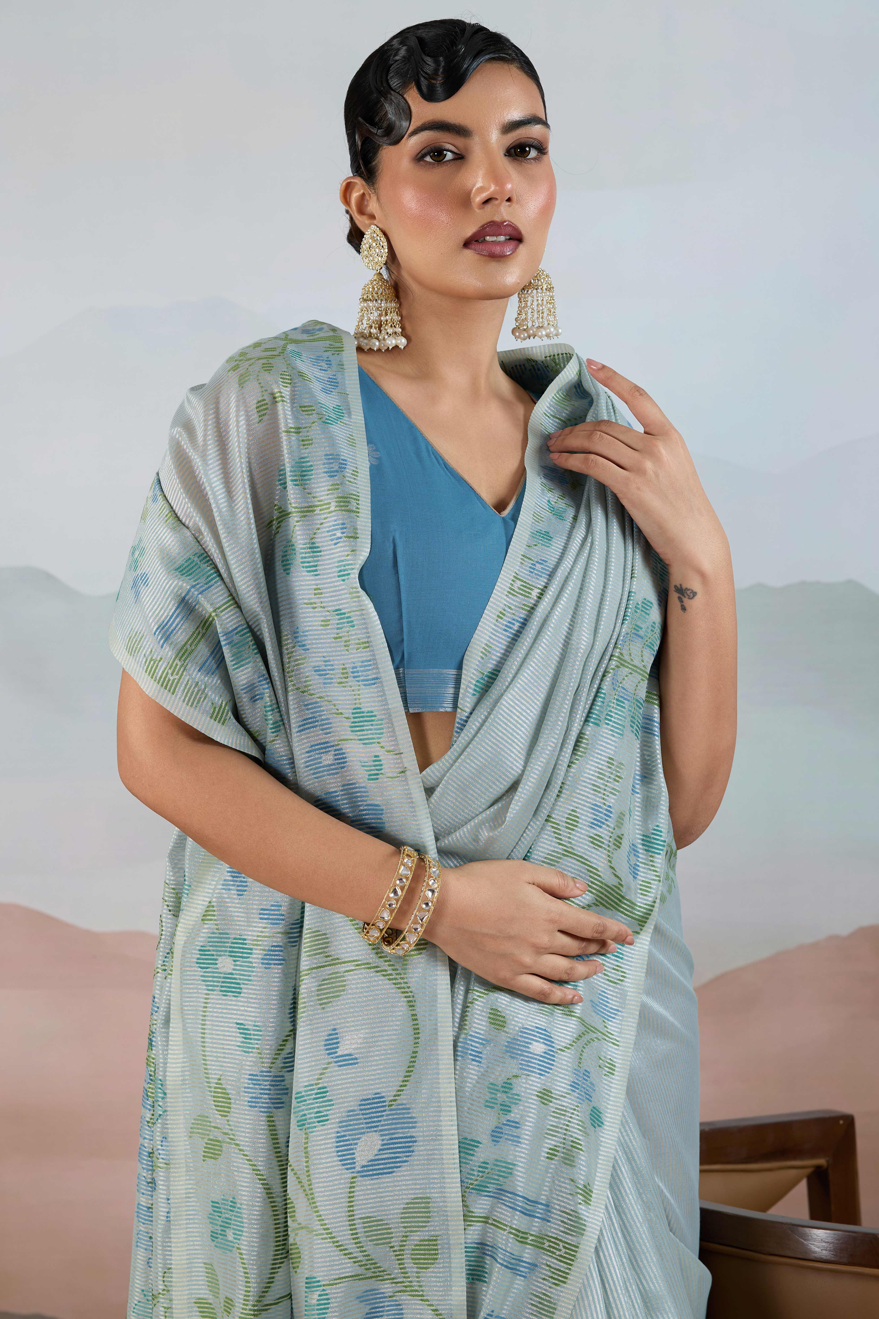 Blue Tissue Silk Saree Showcasing Floral & Striped Weaving With Tassel Adornment
