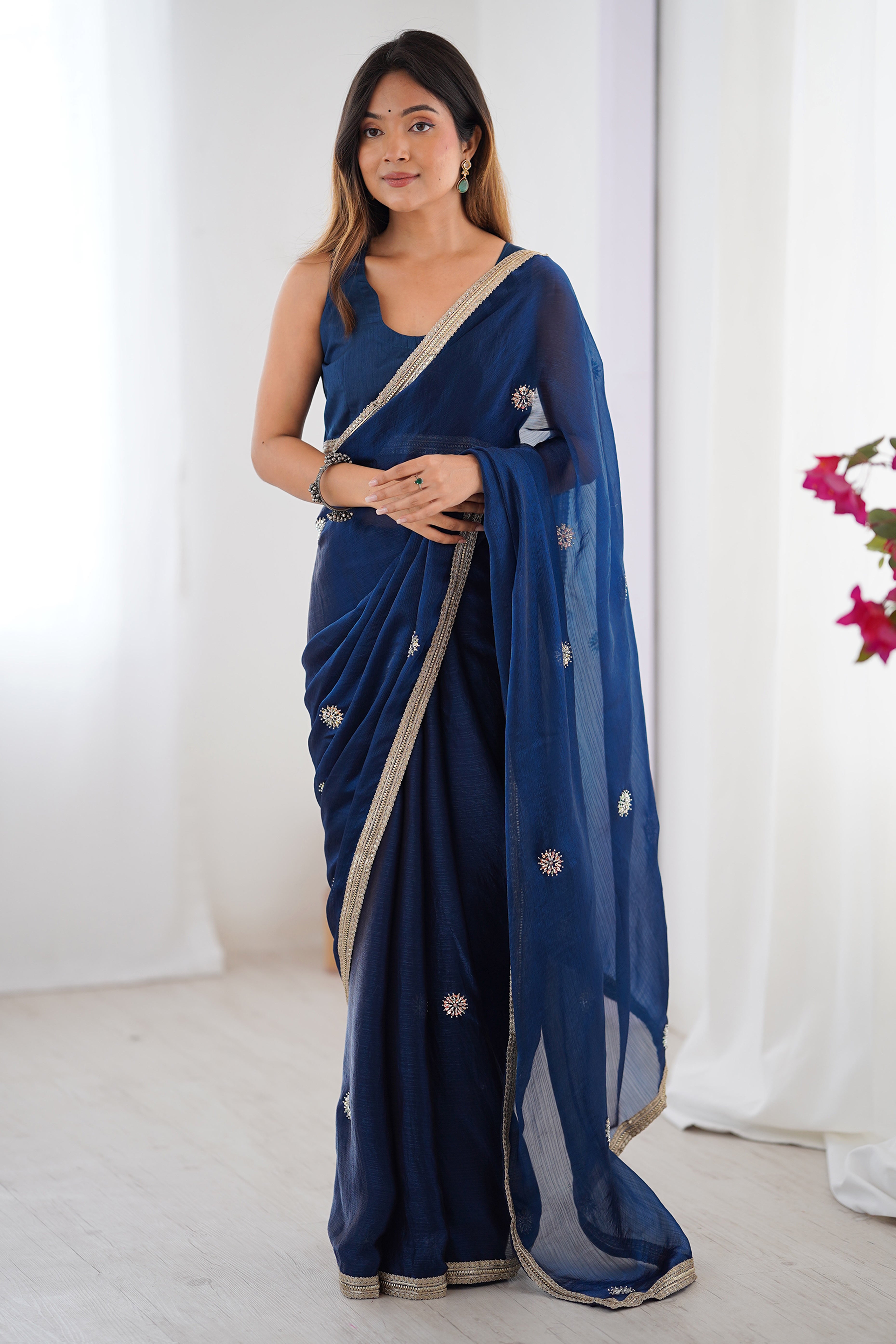 Elegant Blue Organza Saree with Delicate Floral Embellishments and Lace Border
