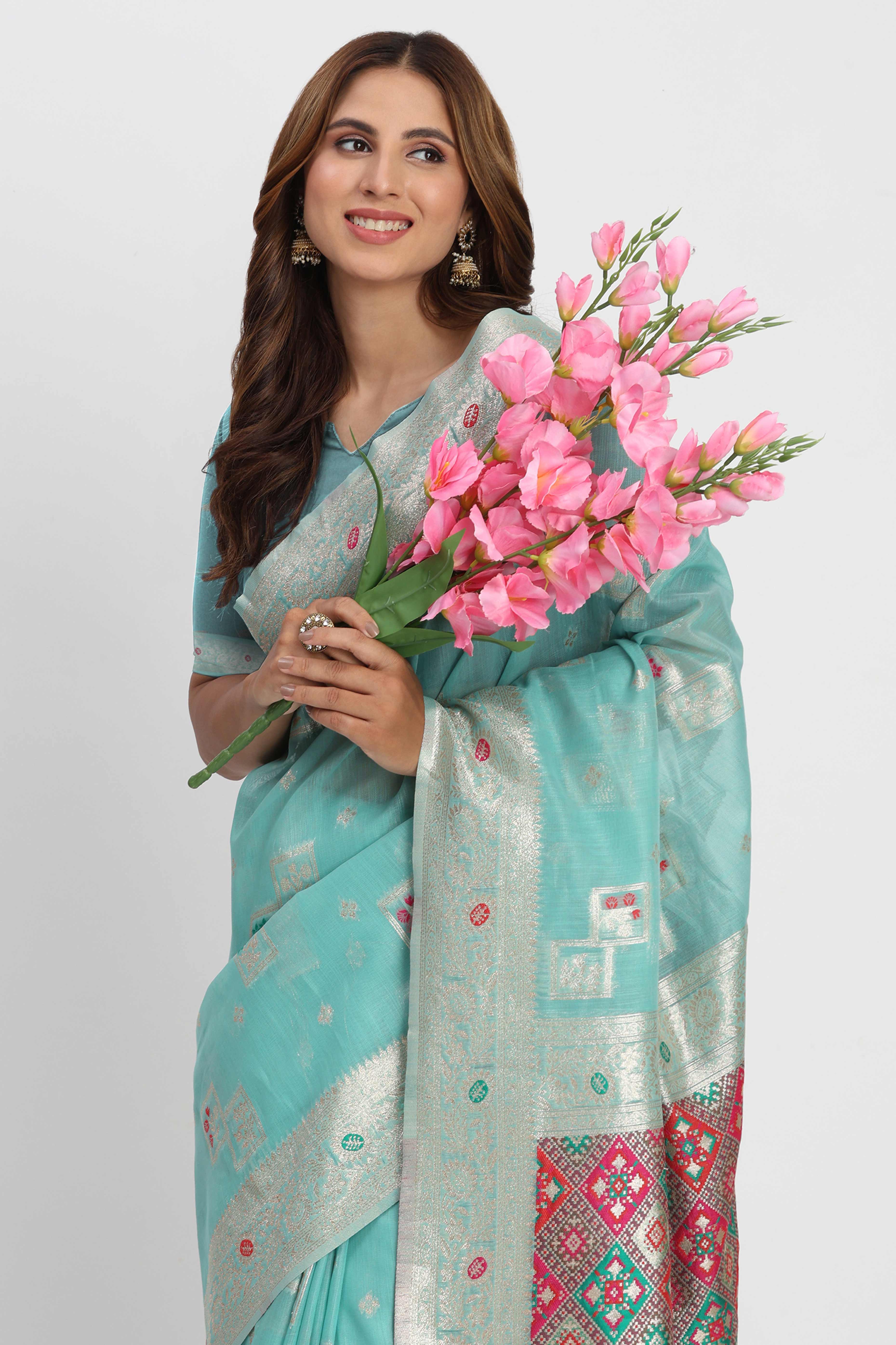 Floral Zari Weaving Brings Regal Beauty To This Turquoise Linen Cotton Saree With Tassel Accents