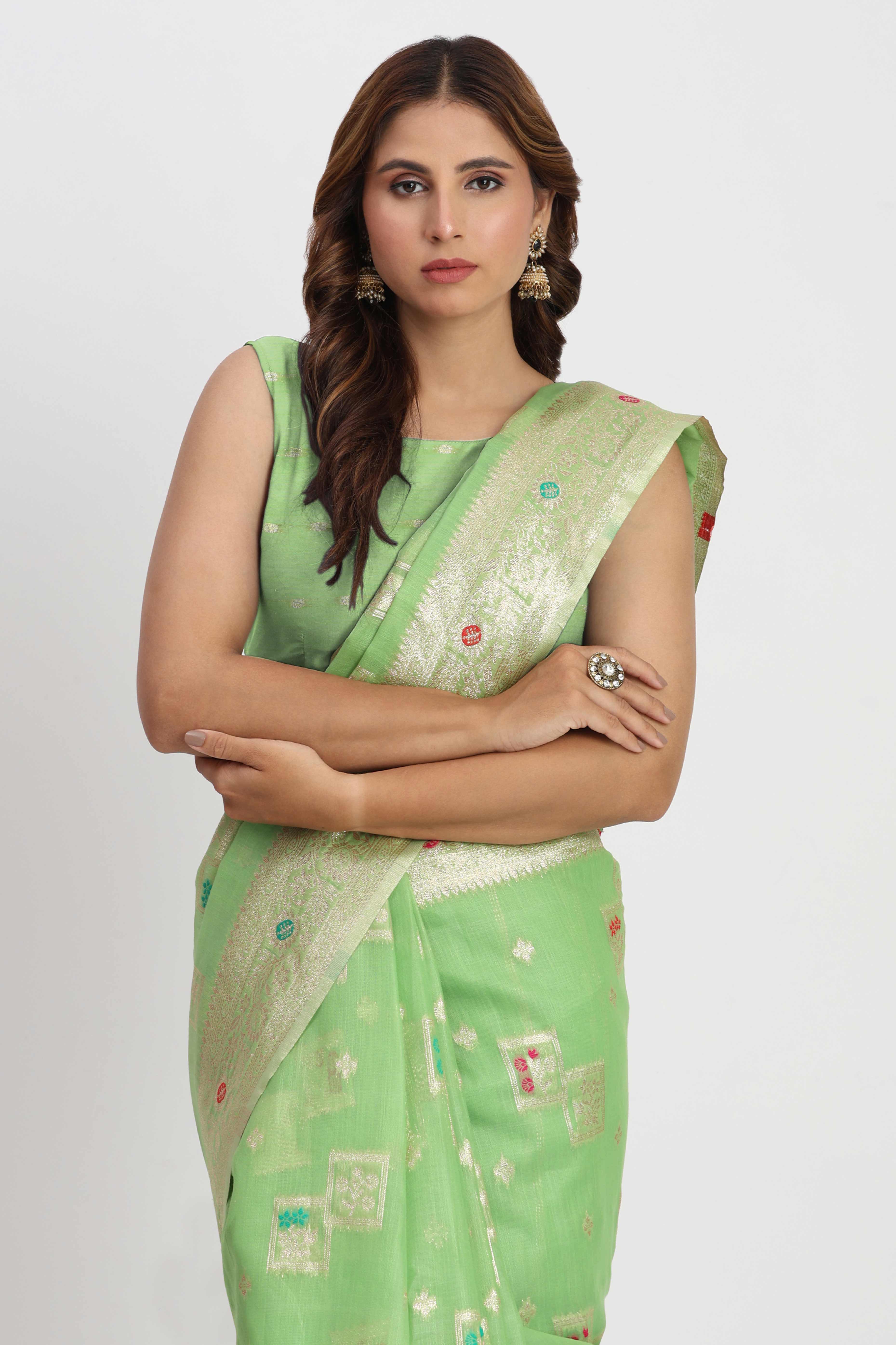 Floral Zari Weaving Brings Regal Beauty To This Light Green Linen Cotton Saree With Tassel Accents