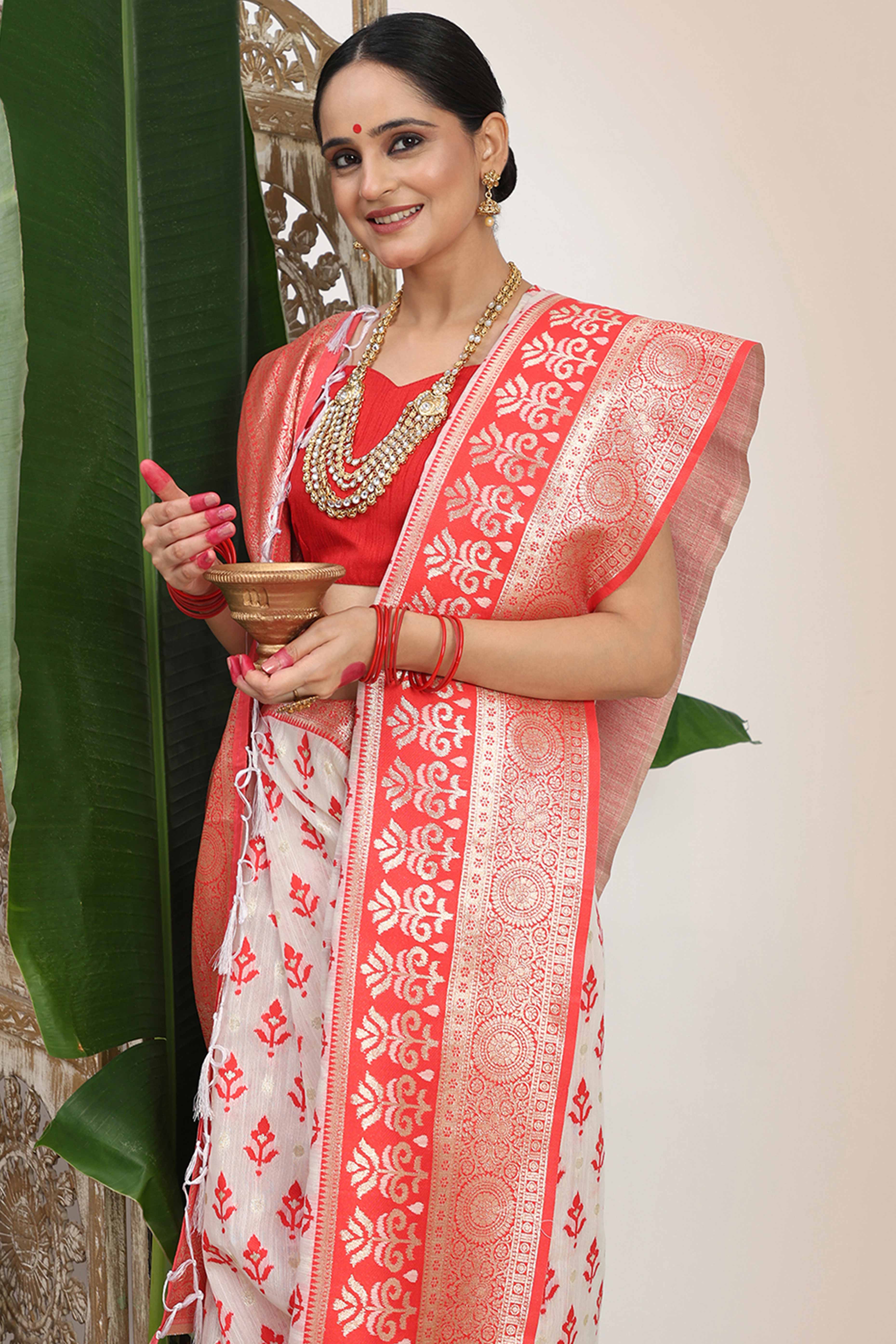 White & Red  Linen Cotton Saree Showcasing Elegant Zari Weaving And A Tassel-Embellished Pallu