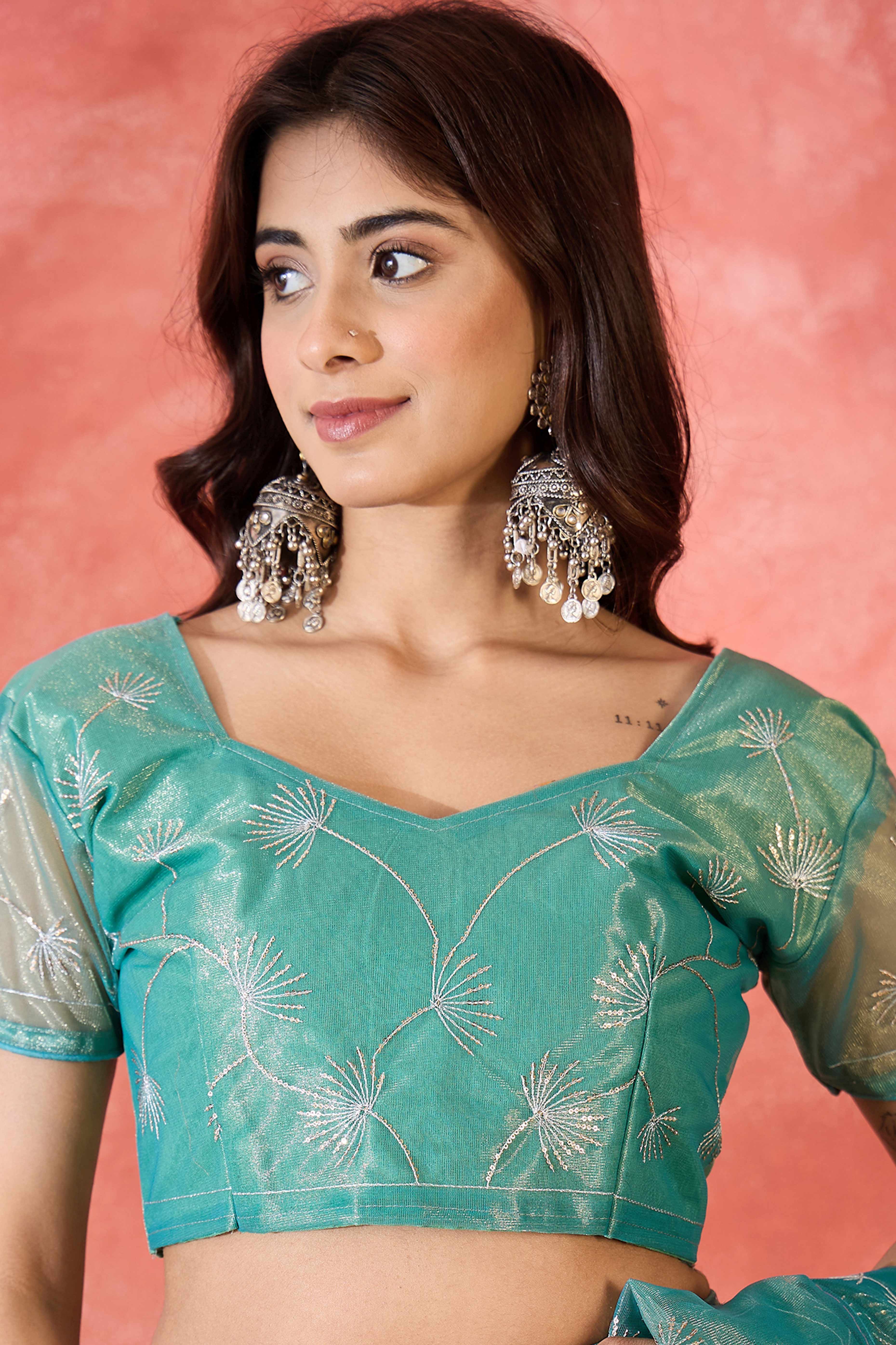 Turquoise Twill Net Saree With Intricate Floral Sequin Work & Flowing Tassel Pallu