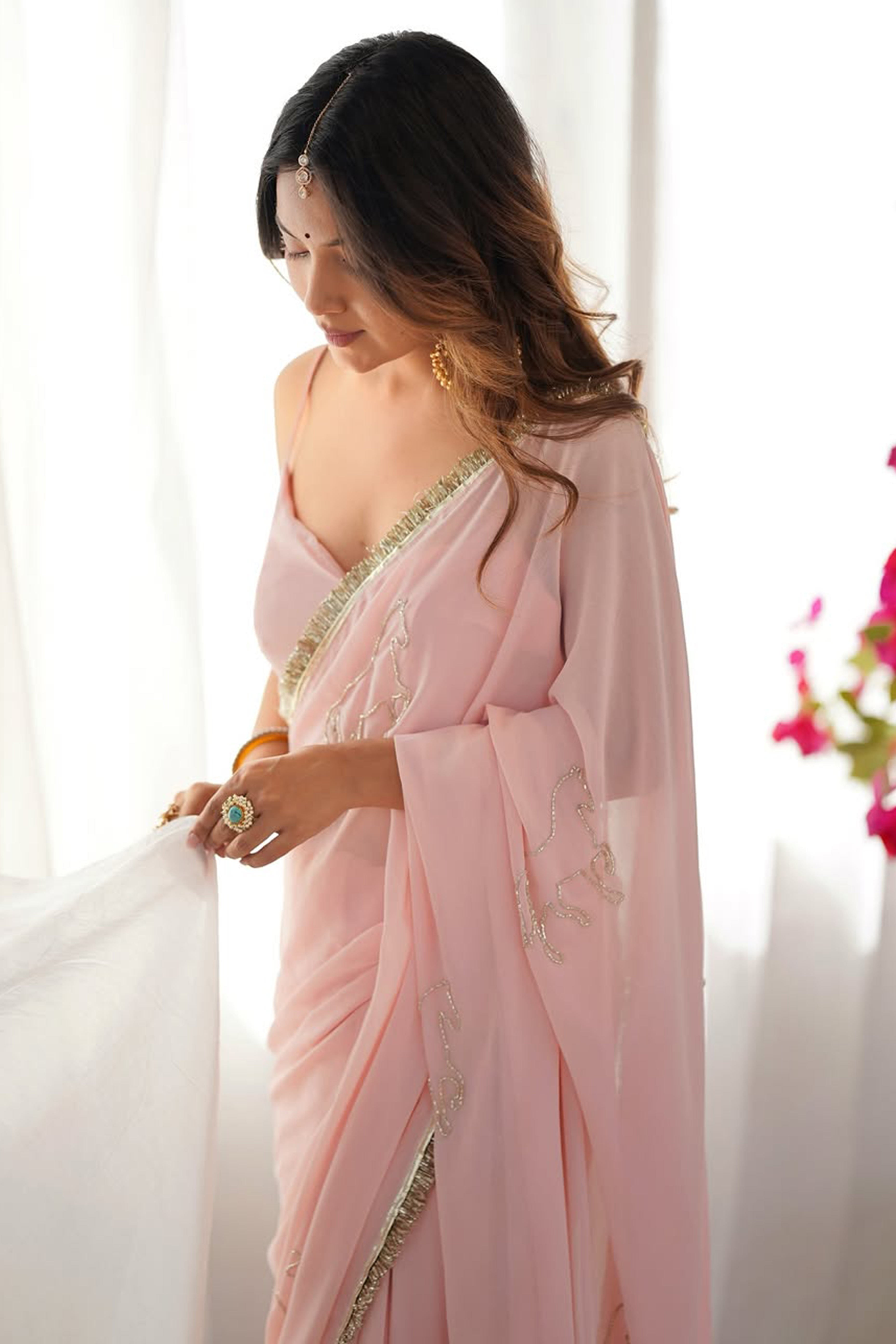 Peach Georgette Saree Adorned with Beads Embroidery and Delicate Lace Detailing for Graceful Evenings