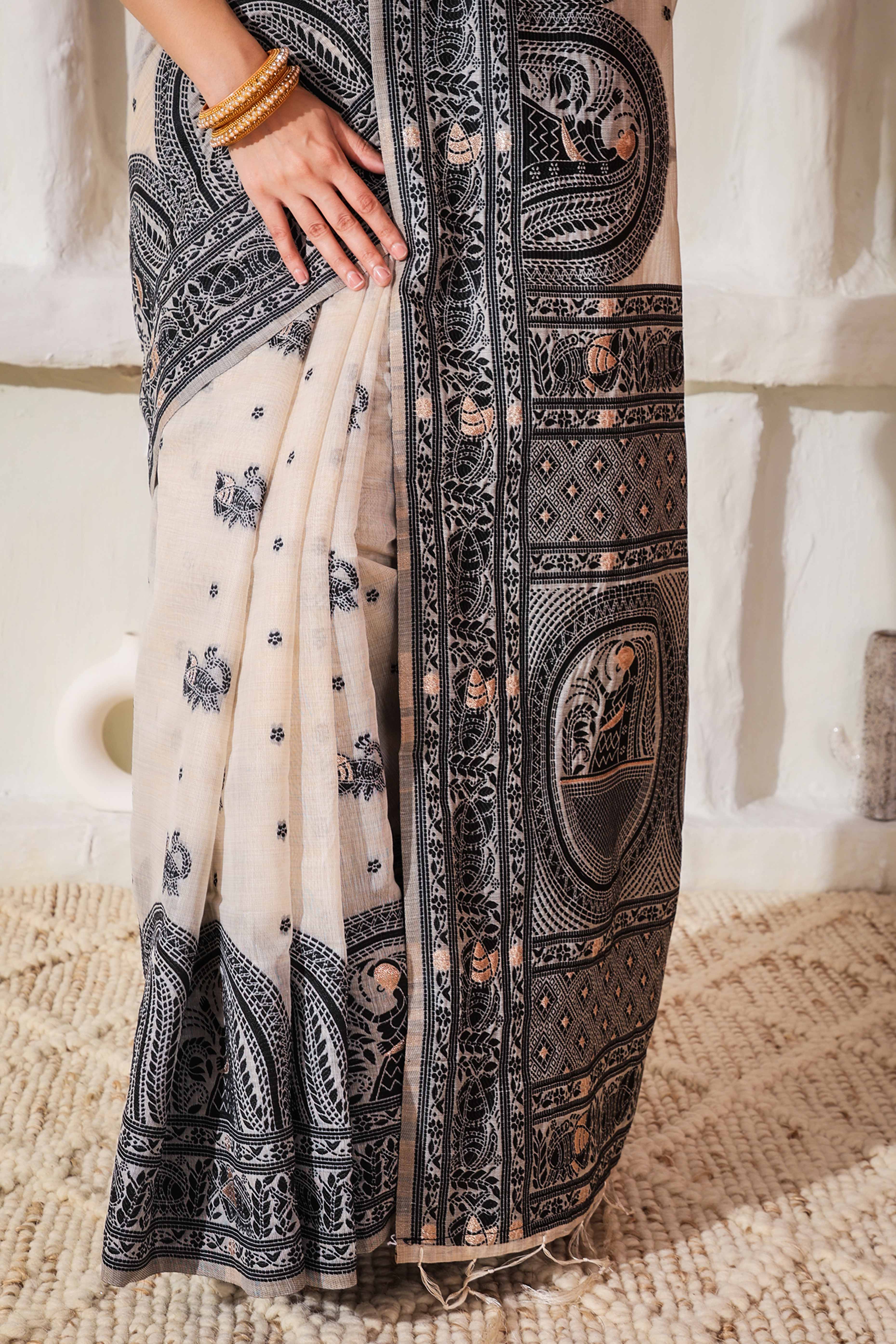 Weaving Cream & Black Linen Cotton Saree Adorned With Graceful Tassel Detailing