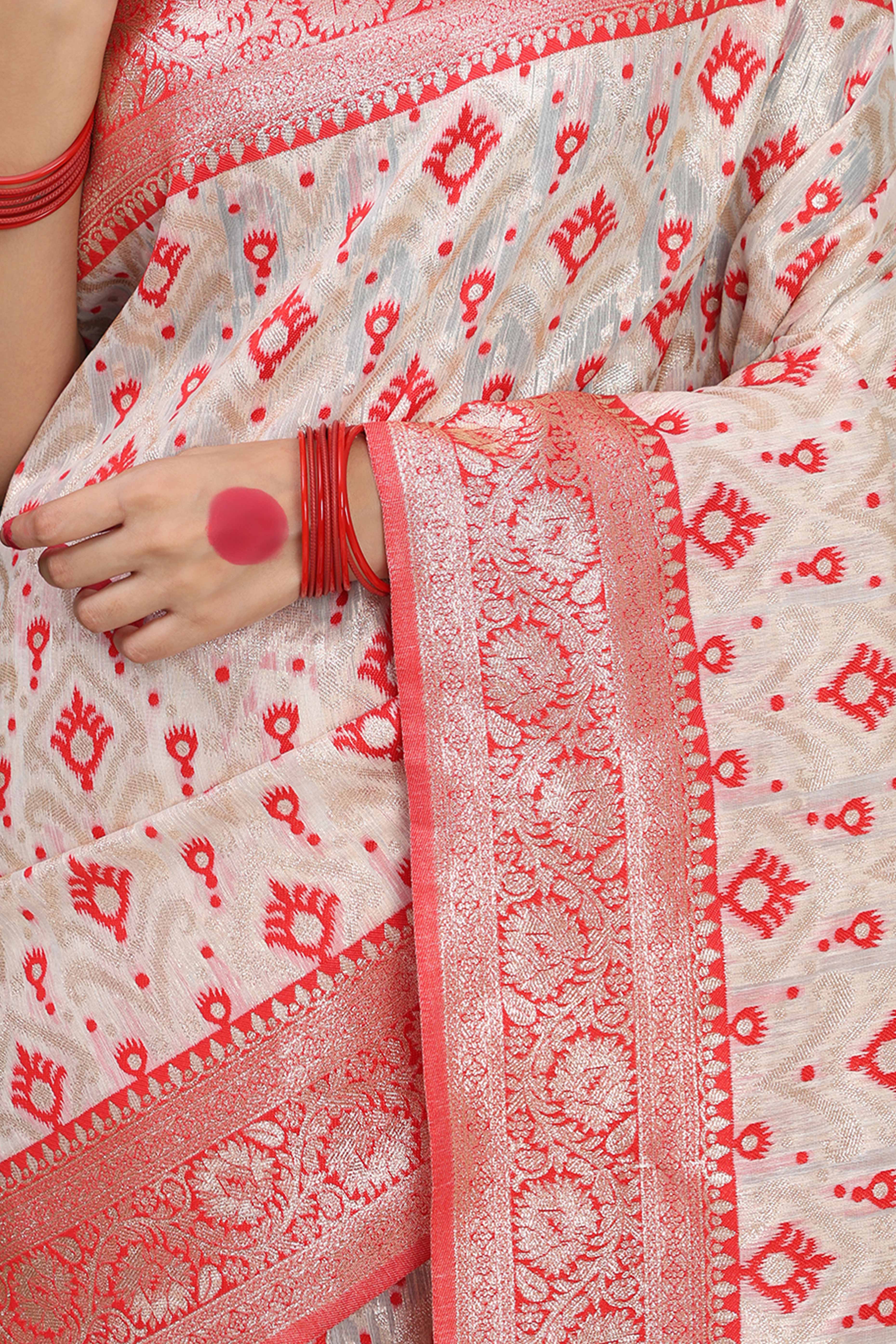 White & Red  Linen Cotton Saree Accented With Rich Zari Weaving And A Decorative Tassel Pallu