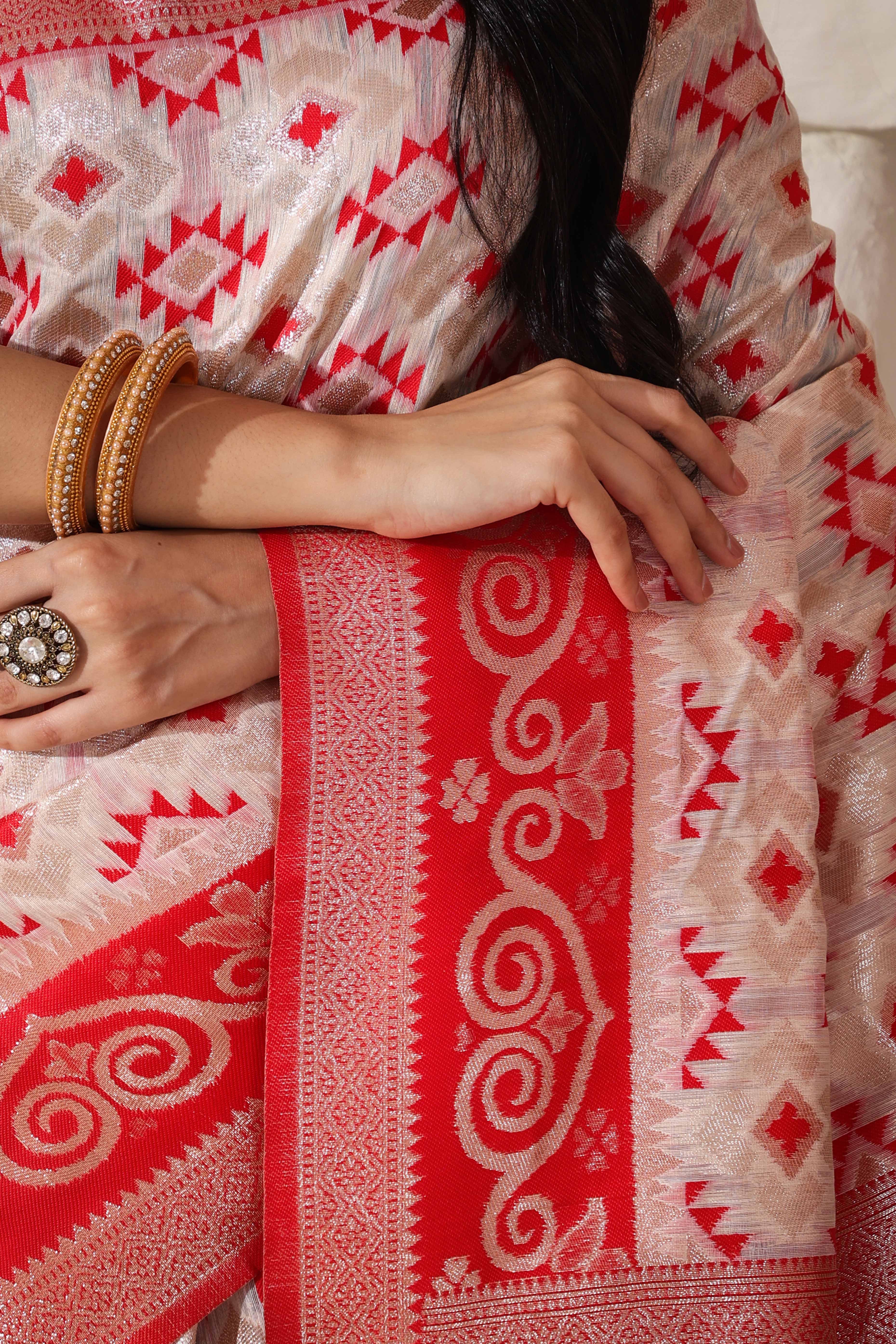 White & Red Linen Cotton Saree Featuring Fine Zari Weaving And A Tasselled Finish