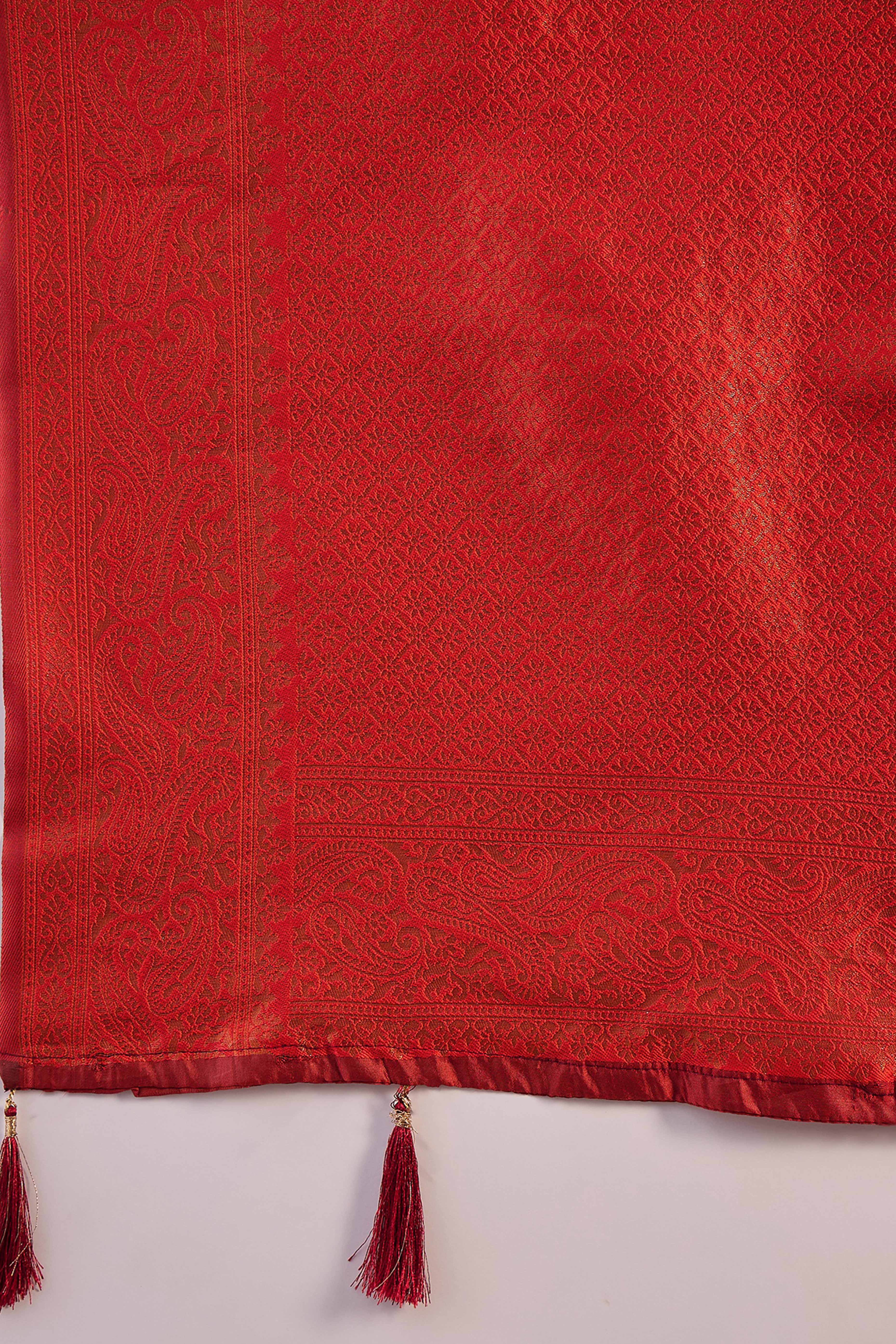 Rust Woven Poly Silk Blend Saree Featuring Floral & Paisley Motifs With Tassel Accents