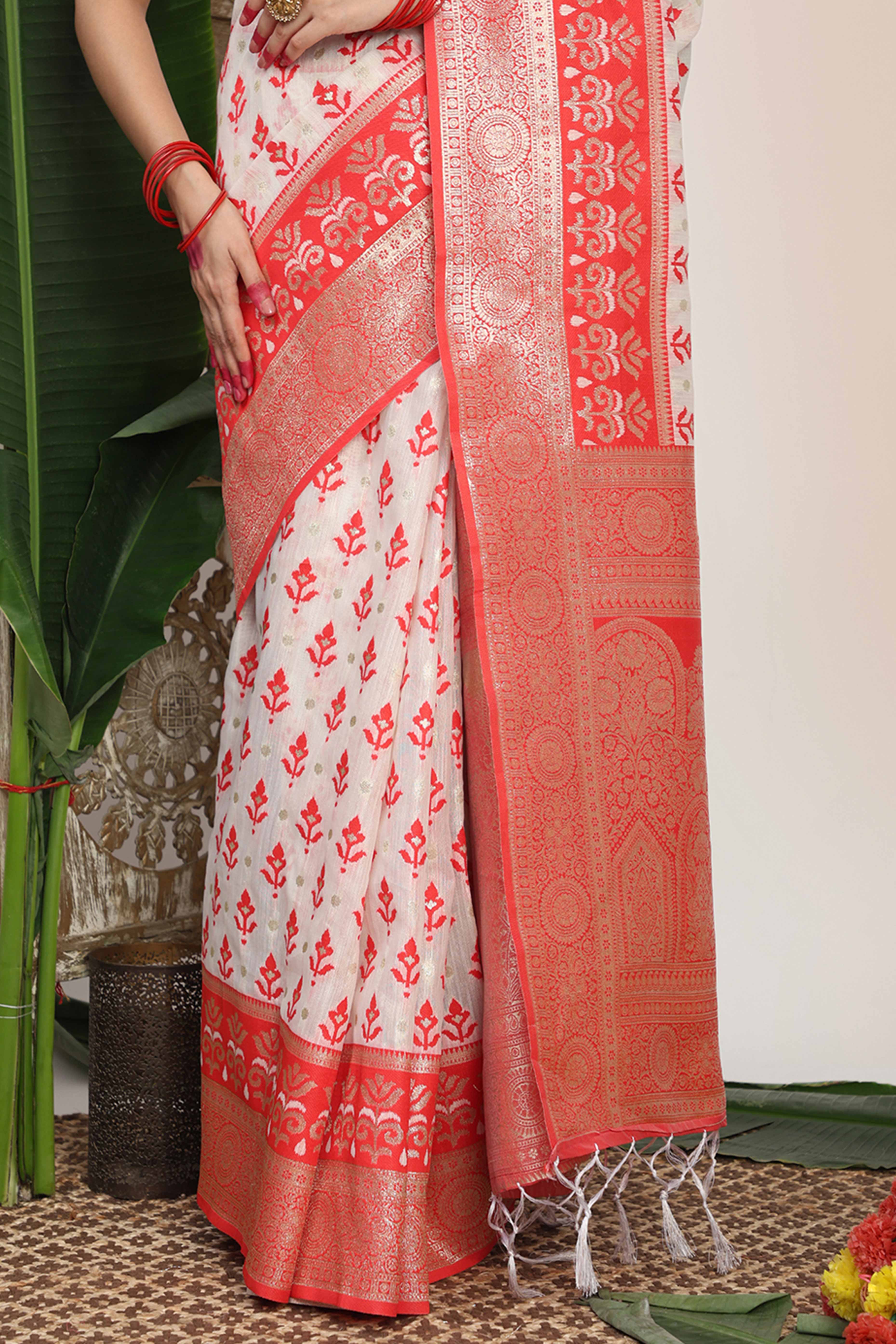 White & Red  Linen Cotton Saree Showcasing Elegant Zari Weaving And A Tassel-Embellished Pallu