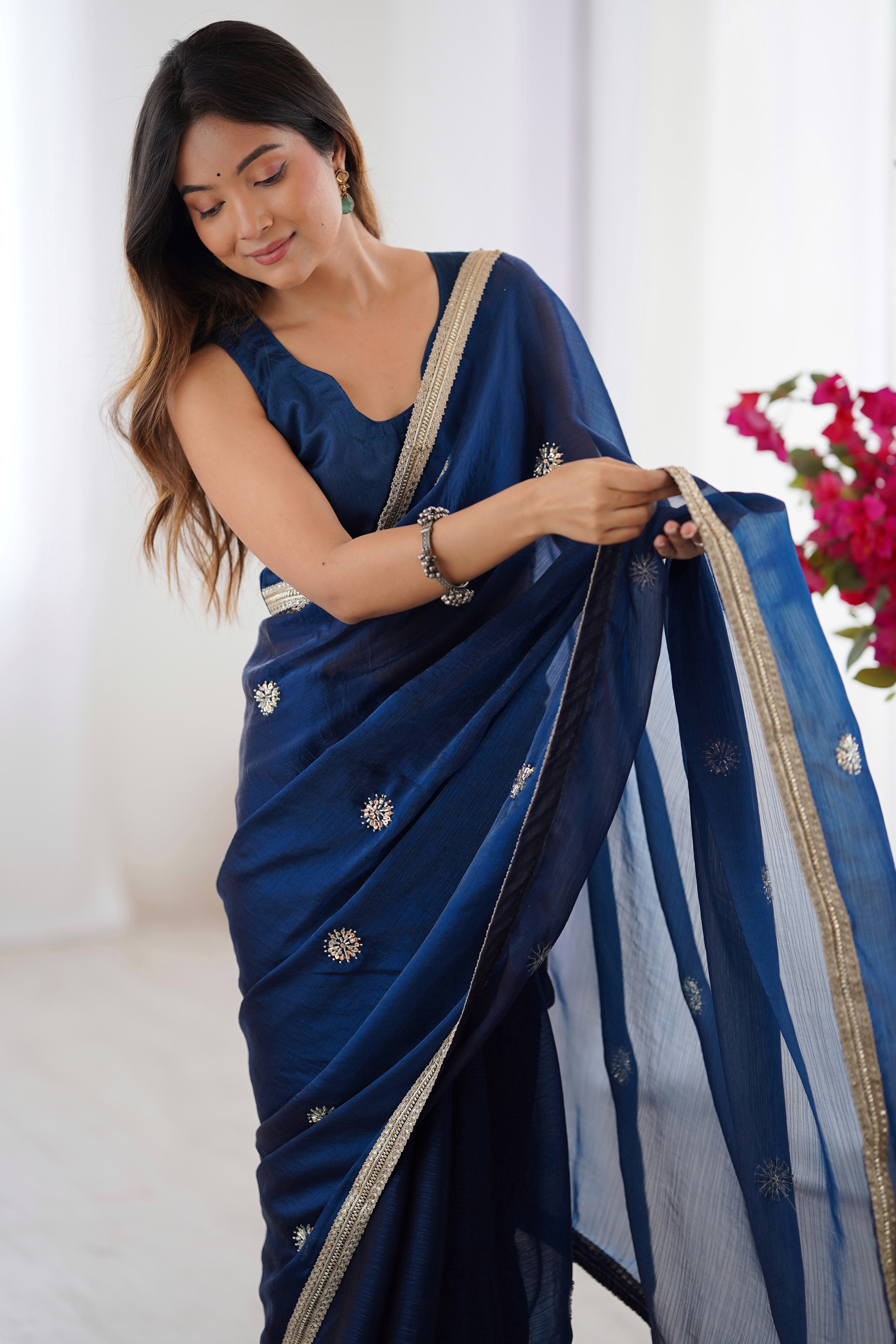 Elegant Blue Organza Saree with Delicate Floral Embellishments and Lace Border