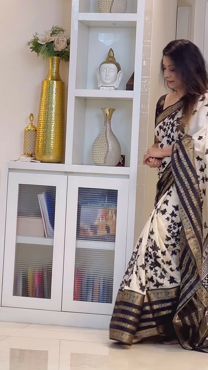 Off White & Black Floral Printed Dola Silk Saree With Zari Border