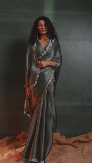 Green Solid Tissue Chiffon Saree Accentuated With A Sparkling Zarkan Work Border