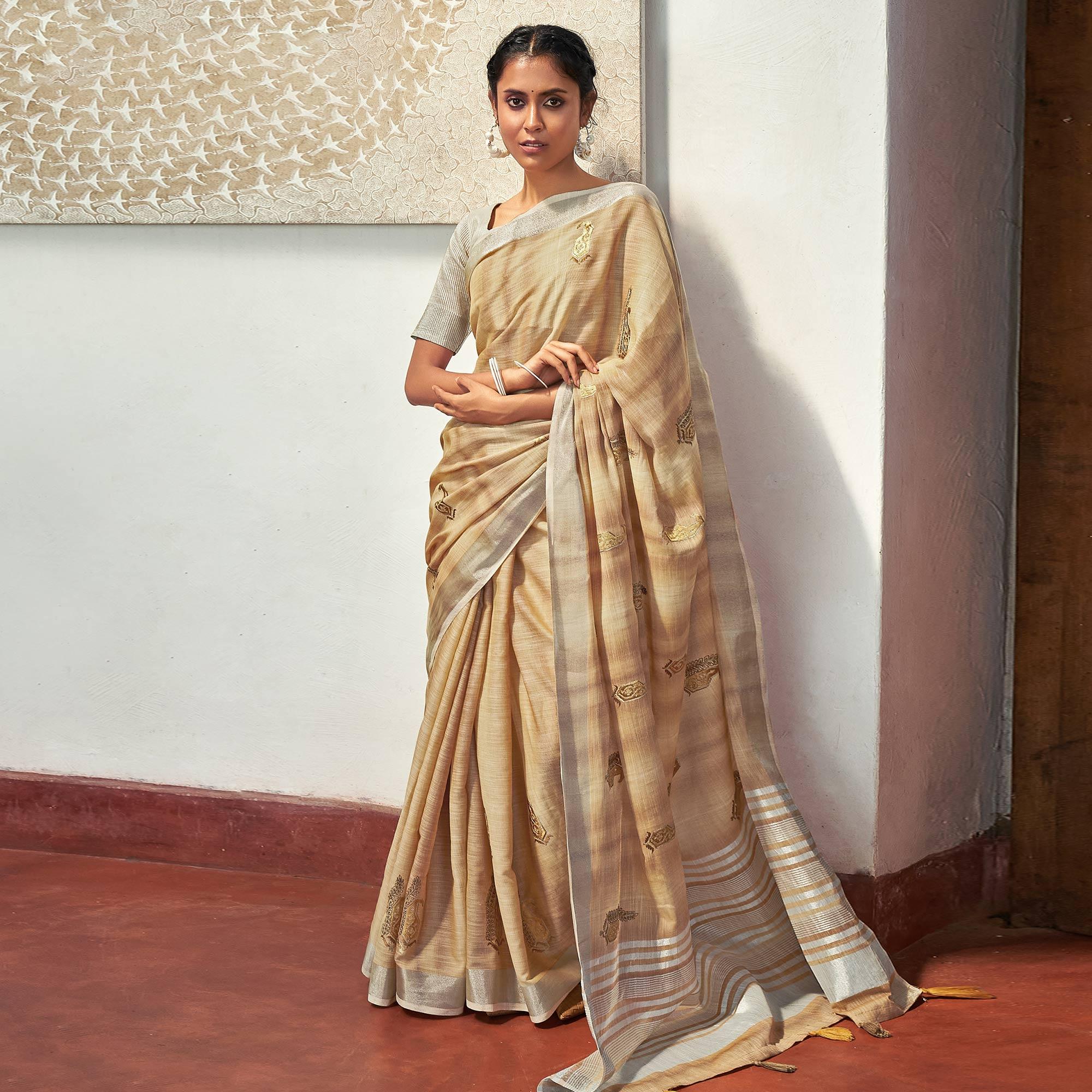 Beige Casual Wear Embroidered Linen Saree With Tassels - Peachmode