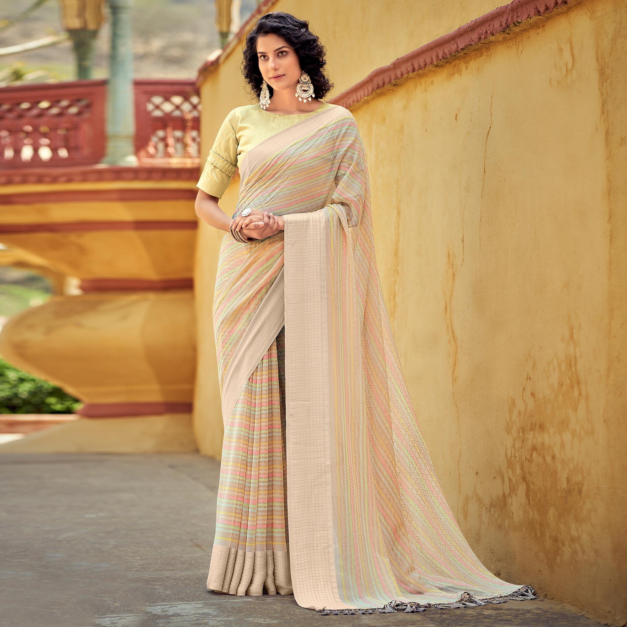 Beige Printed Georgette Saree With Tassels - Peachmode