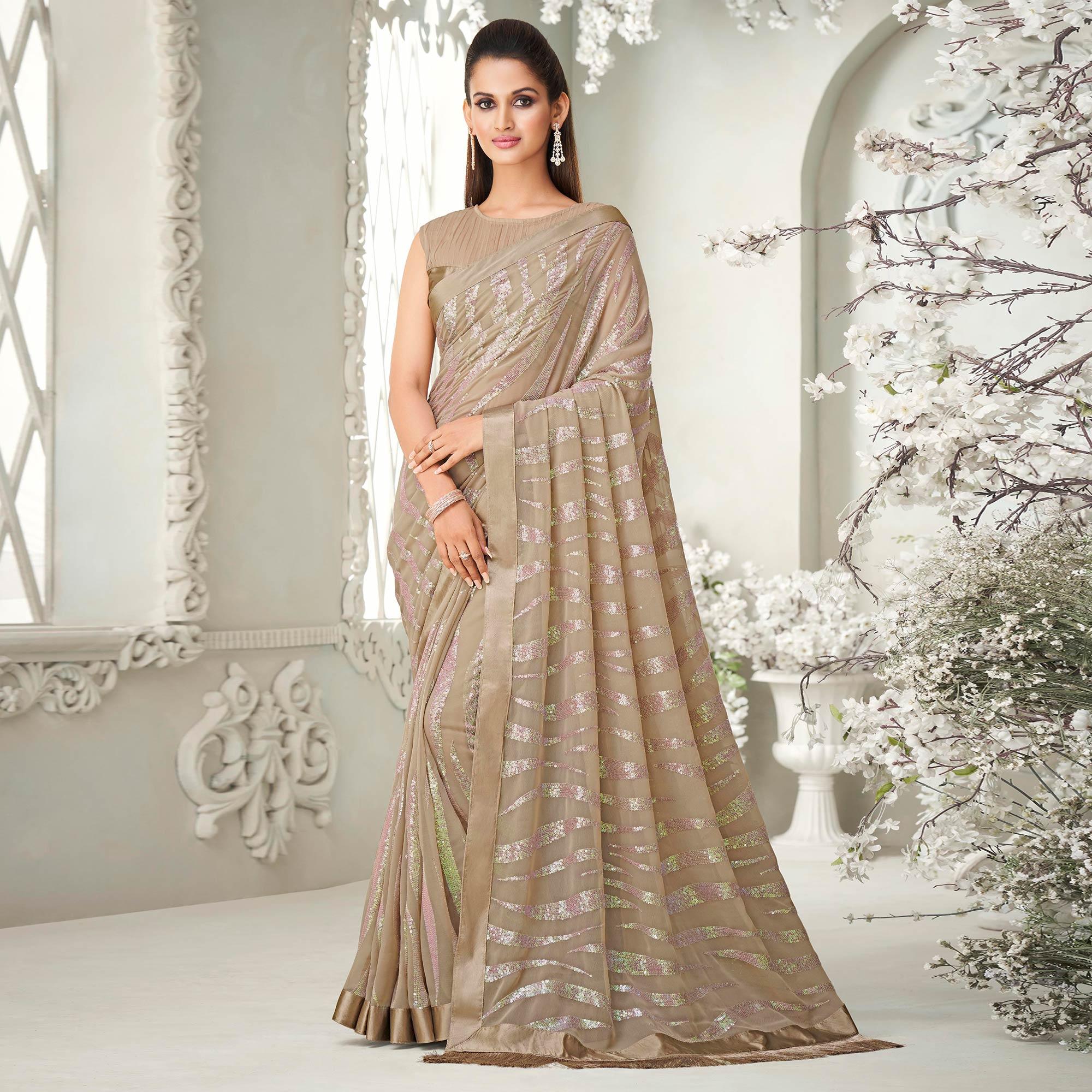 Beige Sequence Embroidered Georgette Saree With Tassels - Peachmode