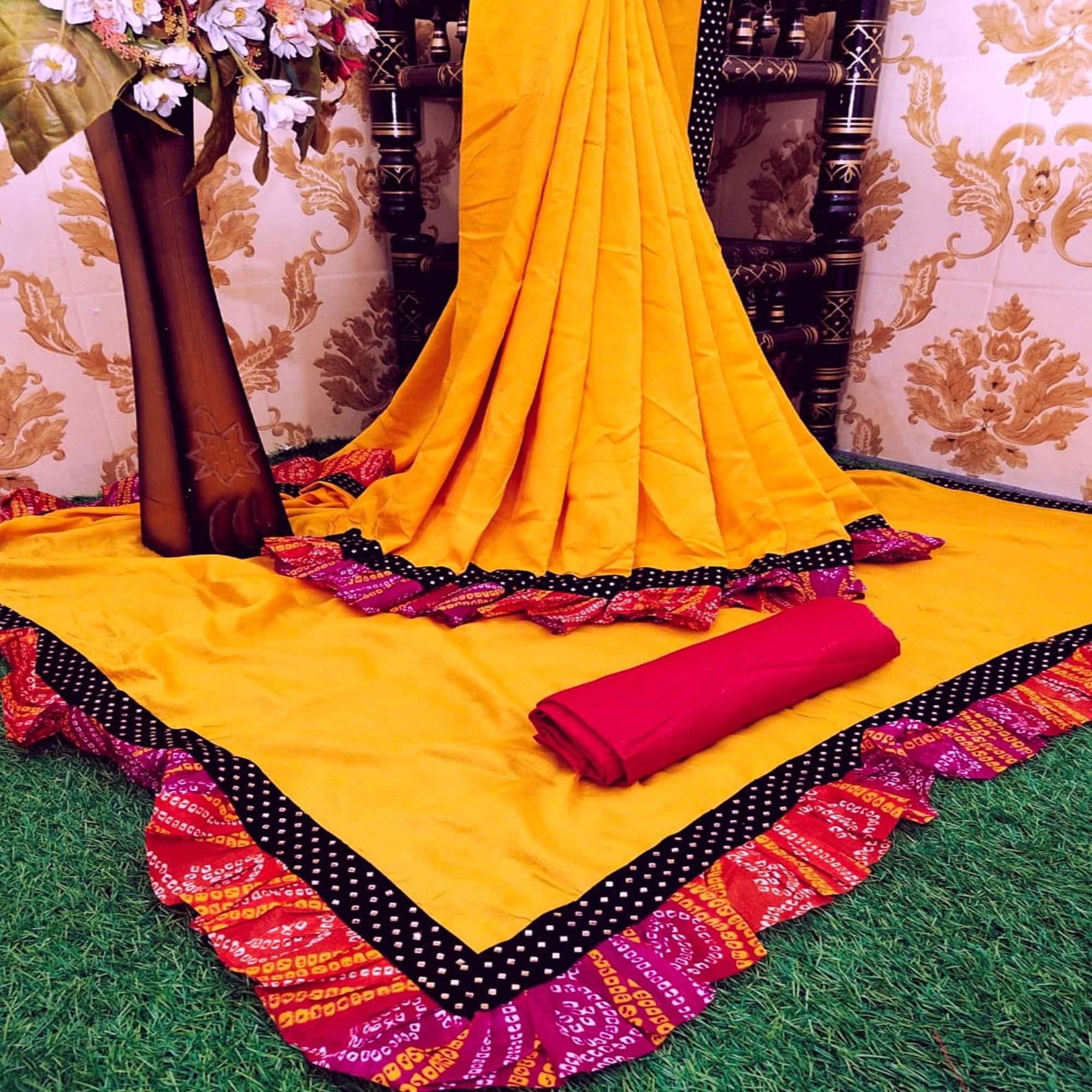 Blooming Mustard Colored Partywear Solid Vichitra Silk Saree With Bandhani Print Ruffle - Peachmode
