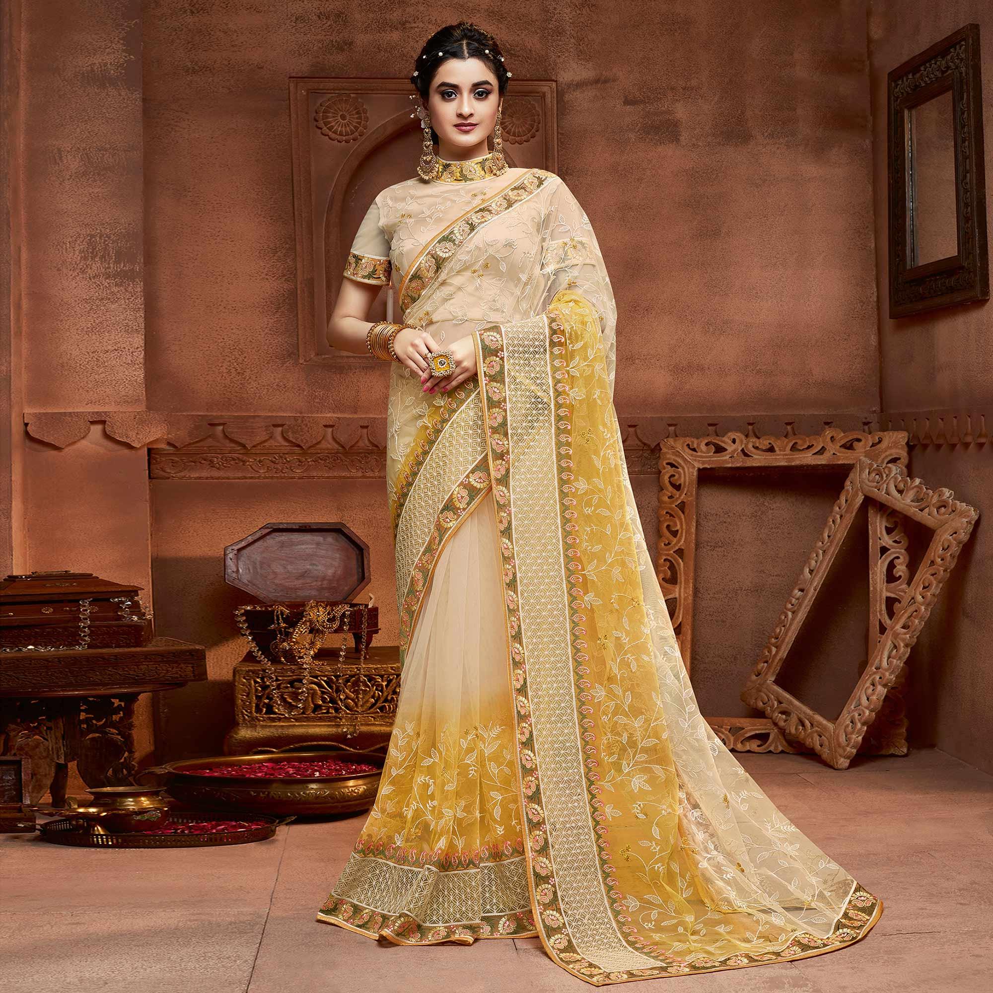 Capricious Beige & Mustard Coloured Partywear Embroidered Soft Net Saree - Peachmode