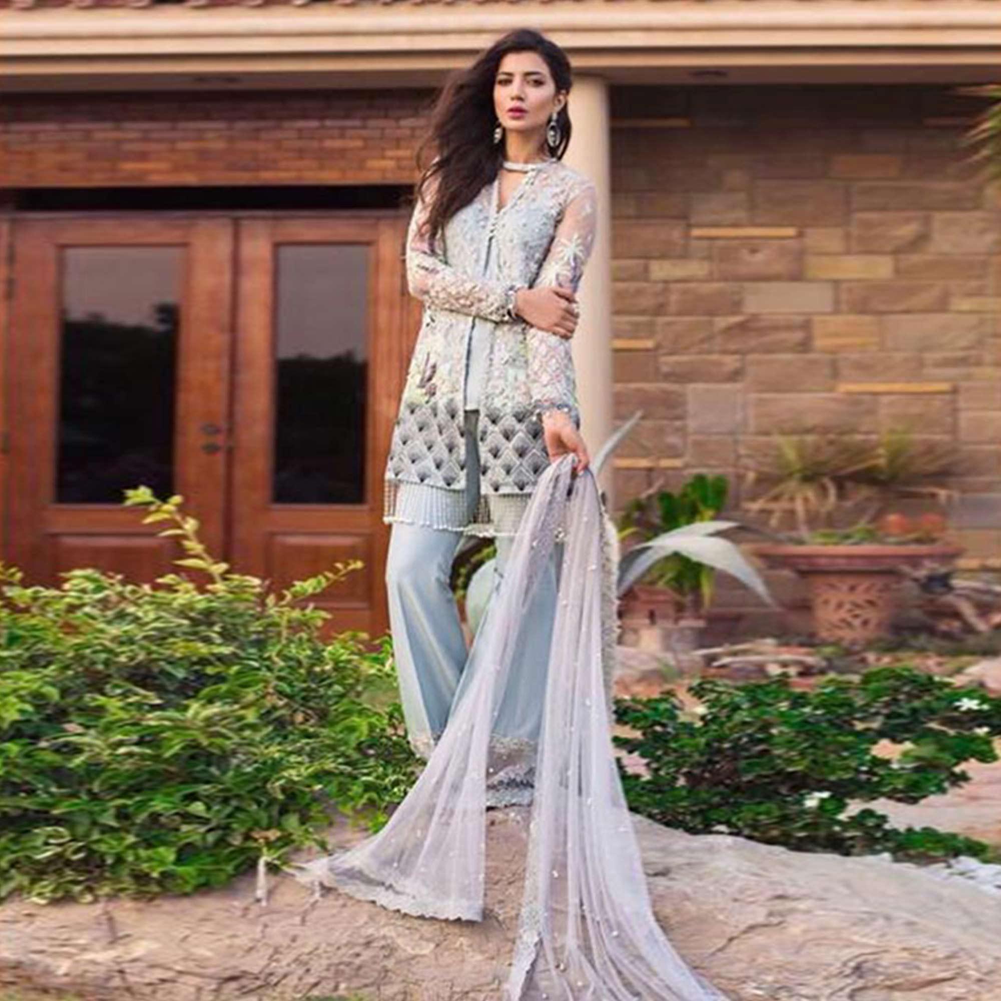 Capricious Light Blue Colored Partywear Embroidered Netted Palazzo Suit - Peachmode
