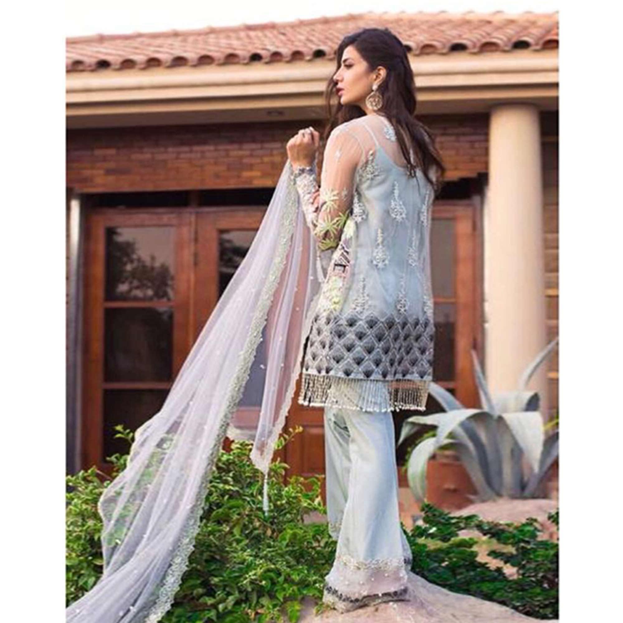 Capricious Light Blue Colored Partywear Embroidered Netted Palazzo Suit - Peachmode